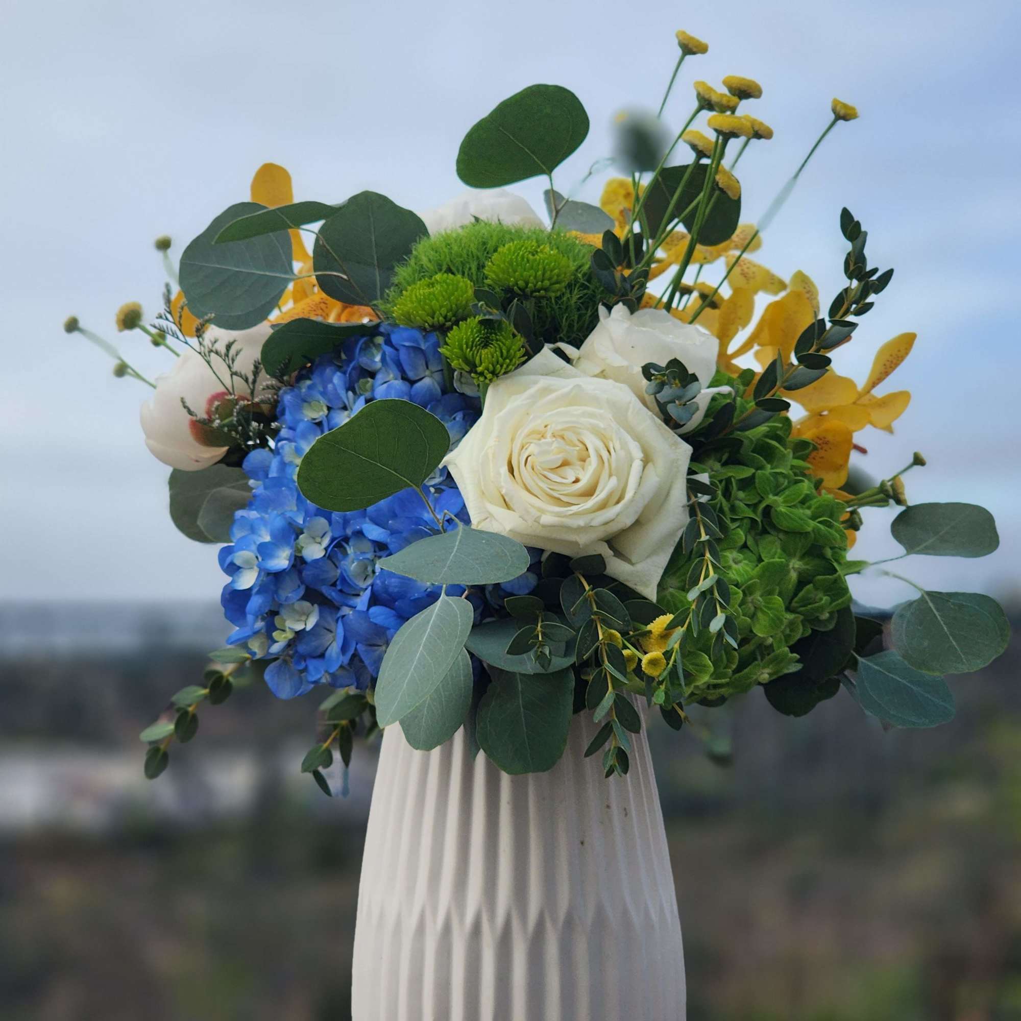 A beautiful arrangement of colorful flowers, in a beautiful vase that can