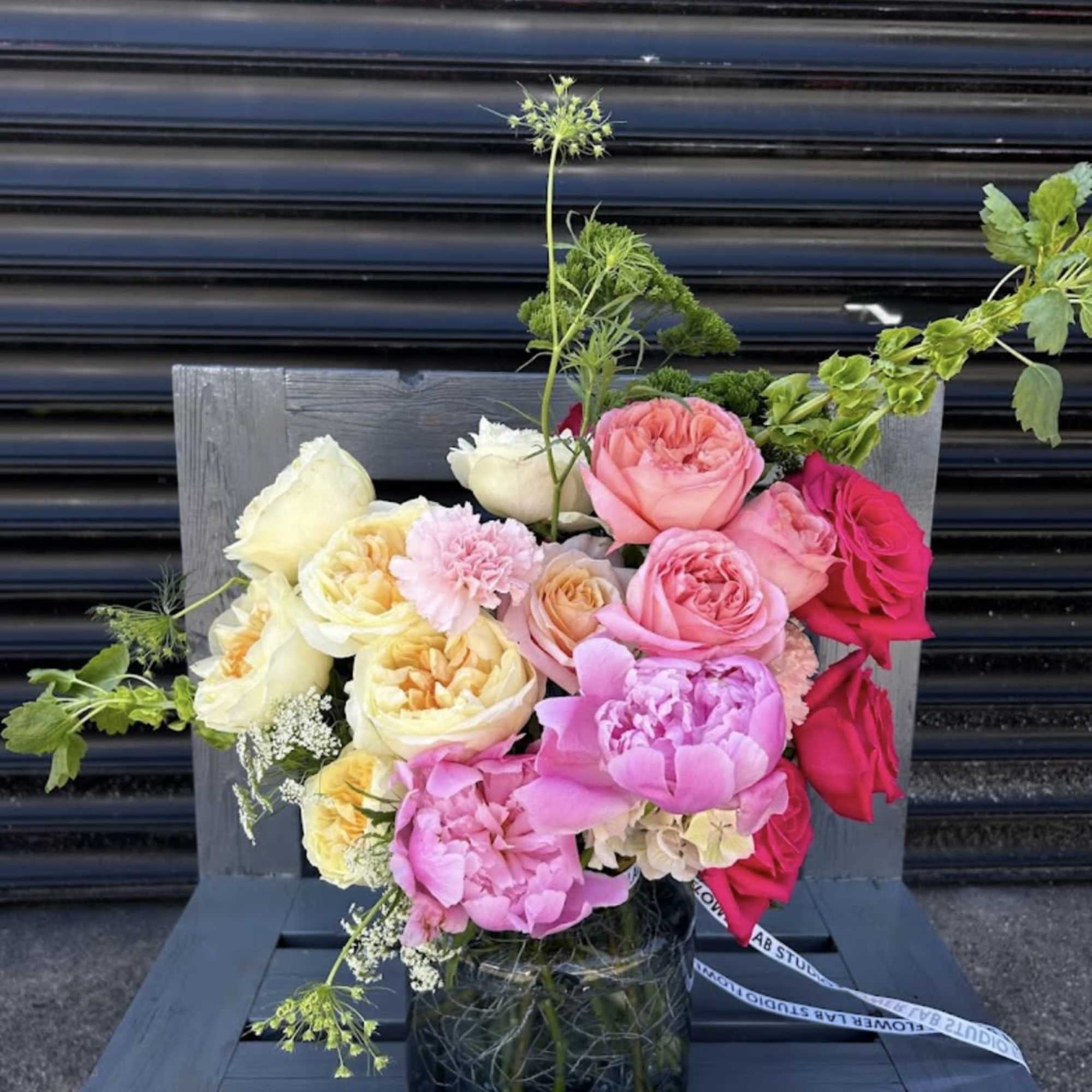 A sweet selection of premium roses and peonies in soft peach, blush