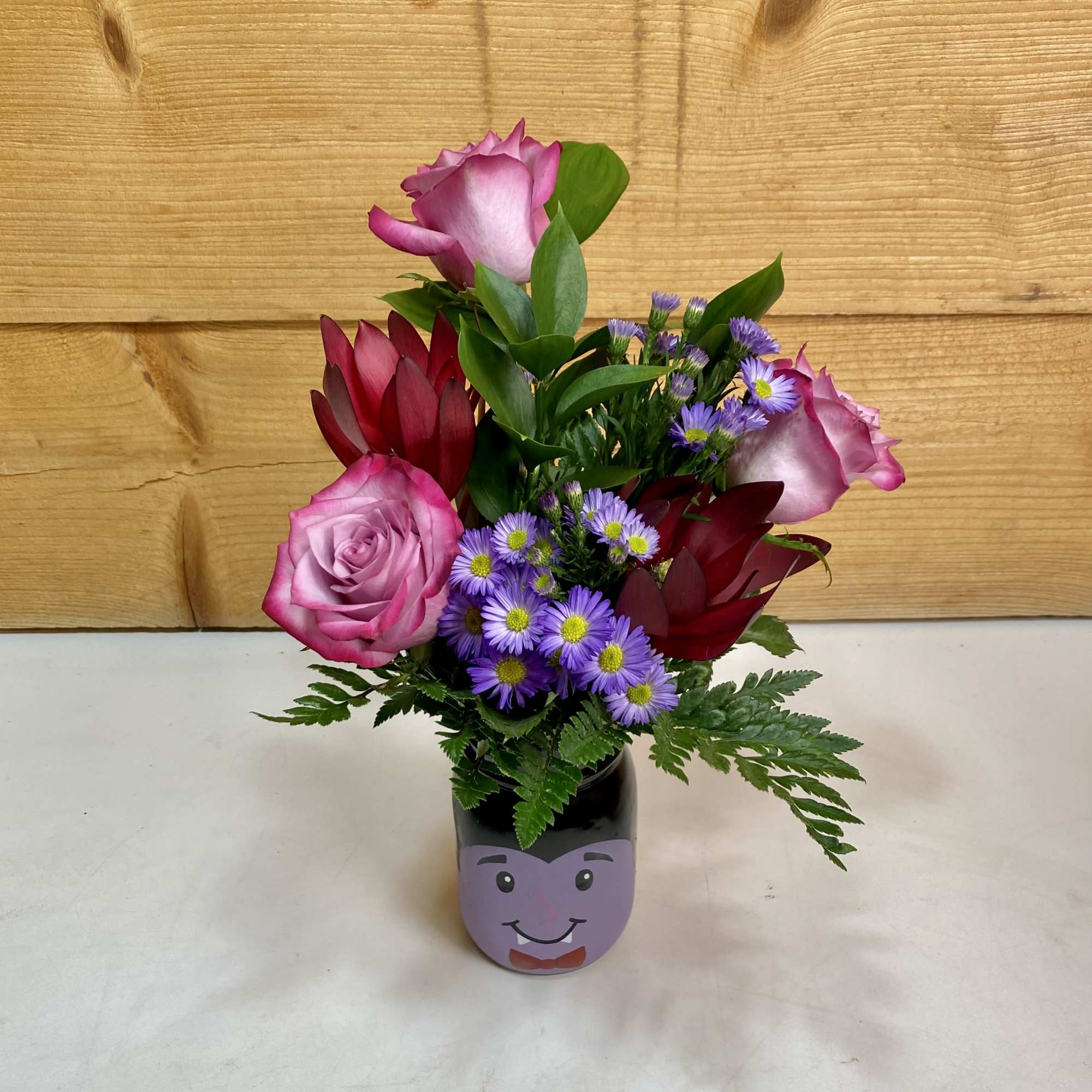 Dracula’s Delight is a scary good arrangement in a vampire mason jar Dracula’s Delight is a scary good arrangement in a vampire mason jar