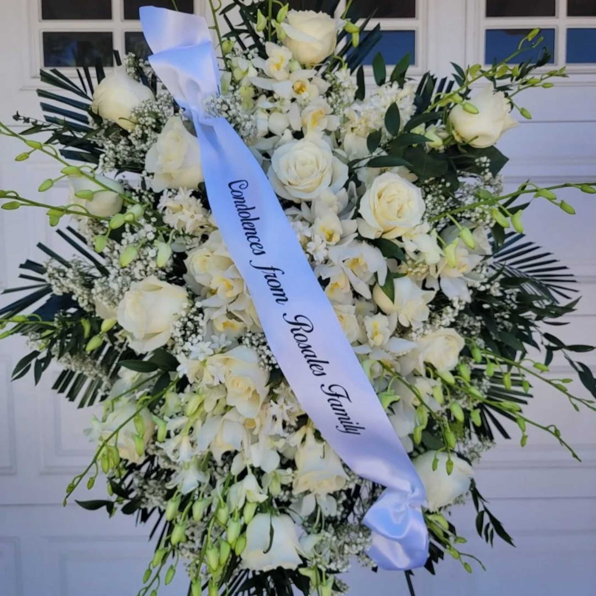 An all white premium orchid tribute, this funeral spray is pure and