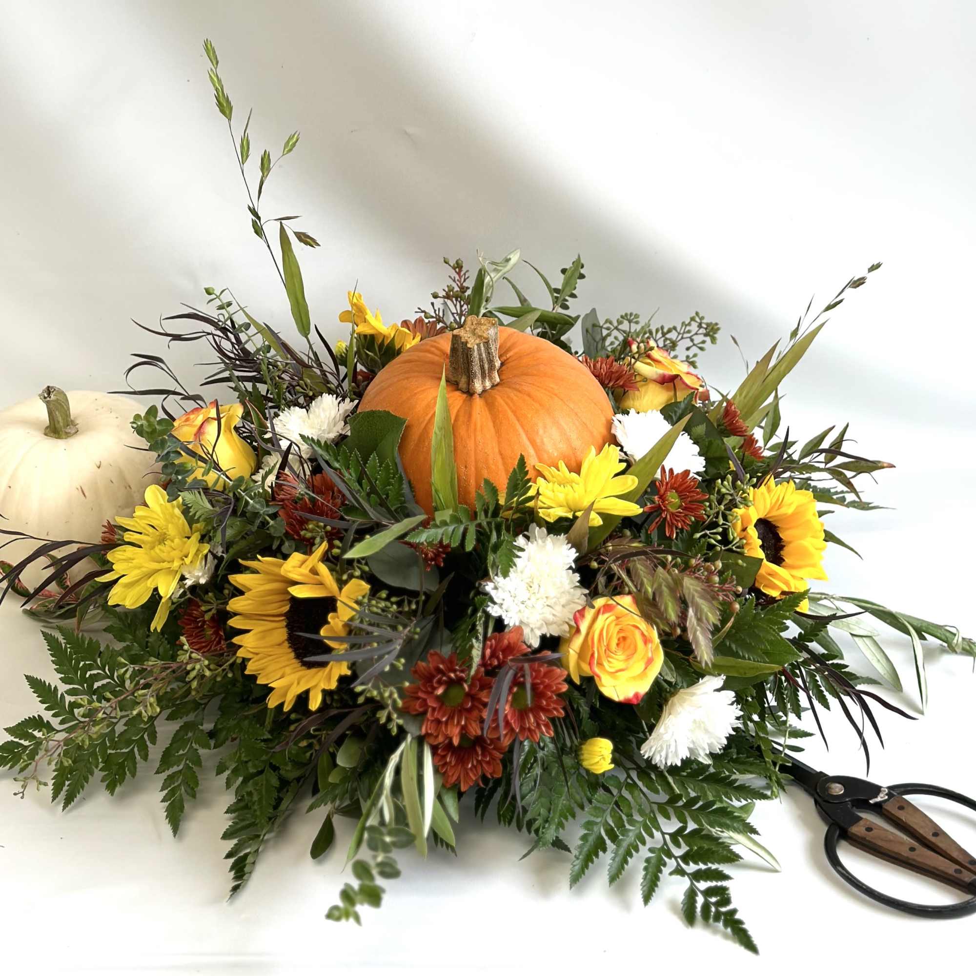A seasonal centerpiece, perfect for the holiday. Includes a fresh pumpkin in