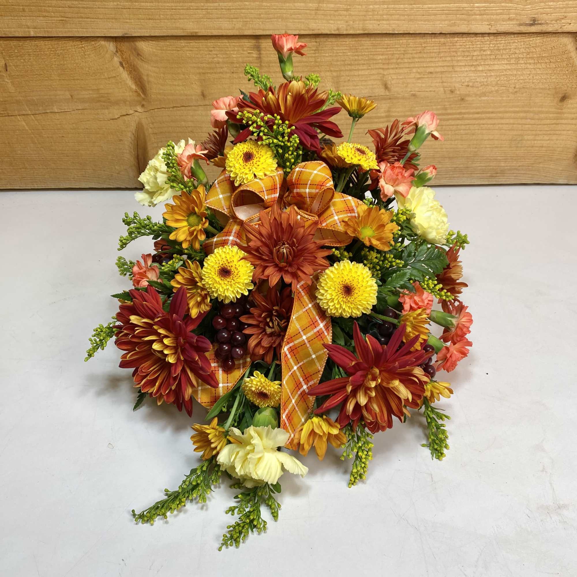The Autumn Bounty Cornucopia, featuring fall colored flowers like daisies and carnations