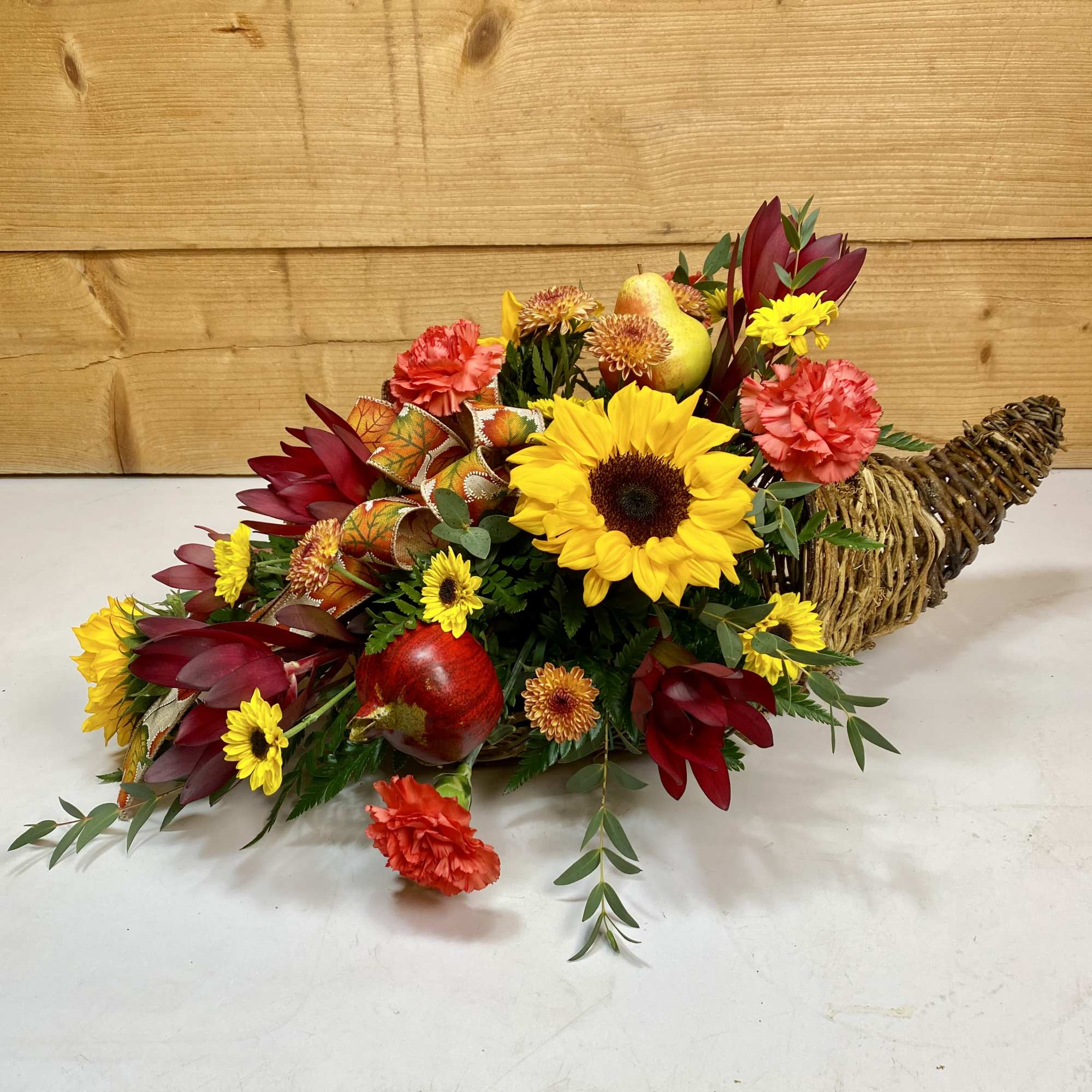 The Sunset Harvest Cornucopia is a magnificent display of autumn blooms, including