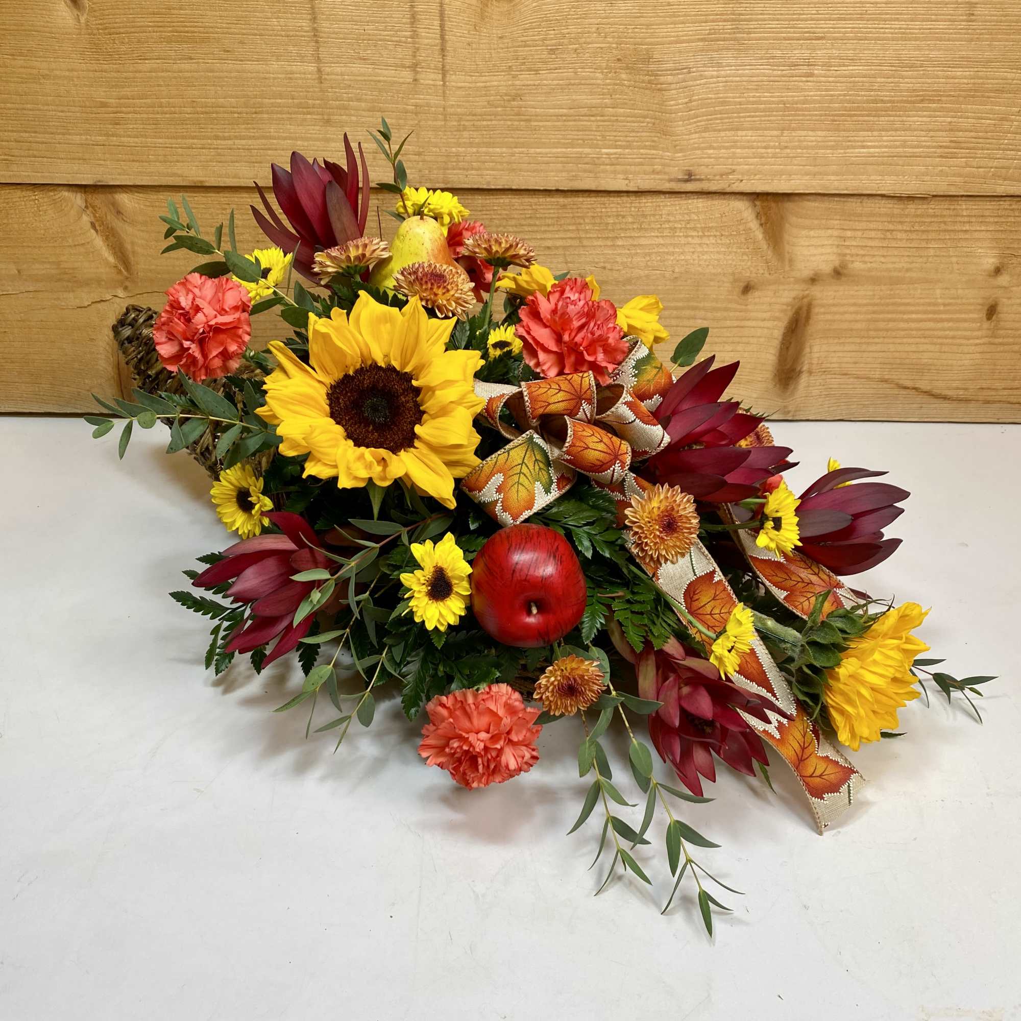 The Sunset Harvest Cornucopia is a magnificent display of autumn blooms, including
