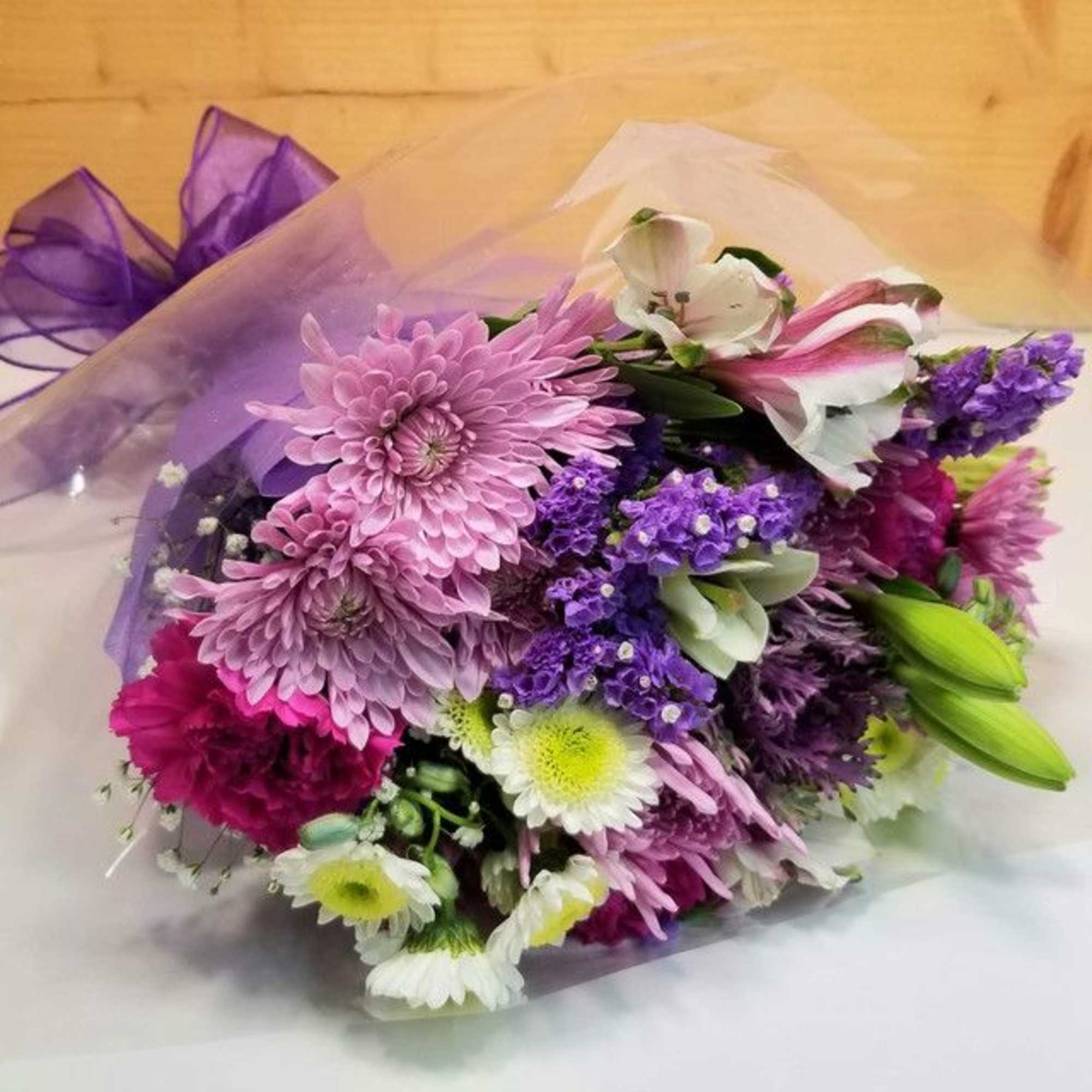 The Wrapped Purple Bouquet by Savilles Country Florist.  Wrapped bouquet of