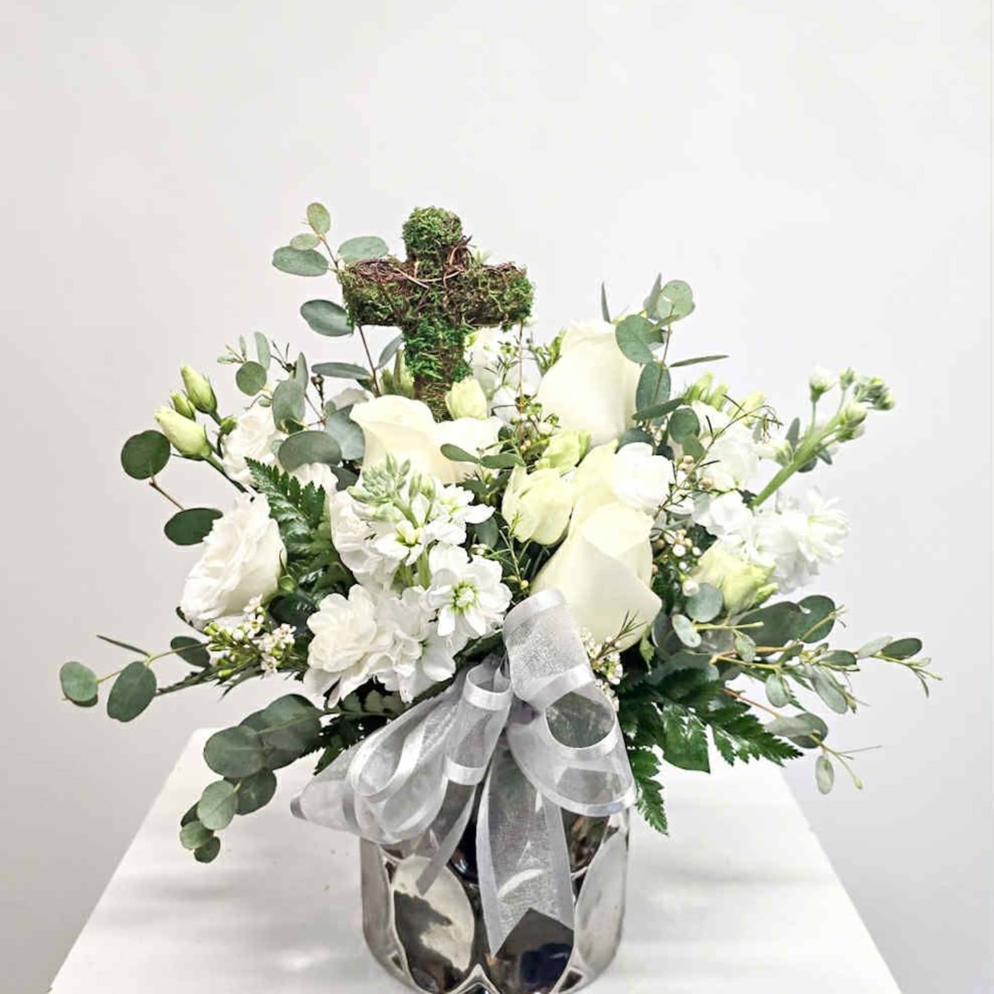Faith is an all white arrangement full of white blooms, eucalyptus and