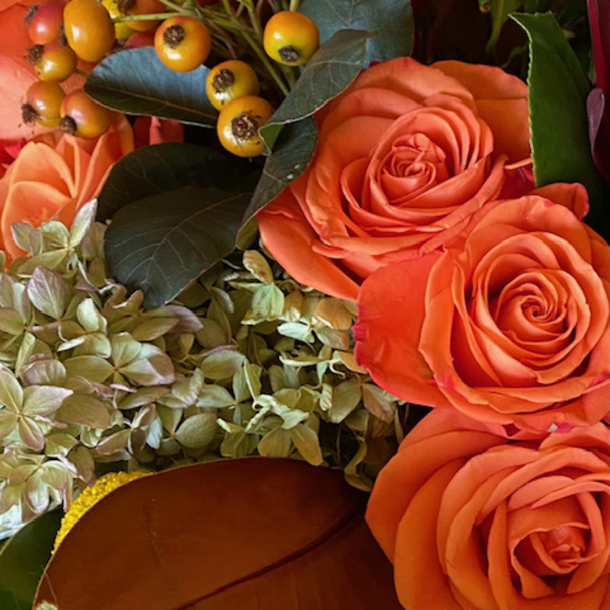 A variety of seasonal blooms in shades of pear, tangerine, ochre. Blooms