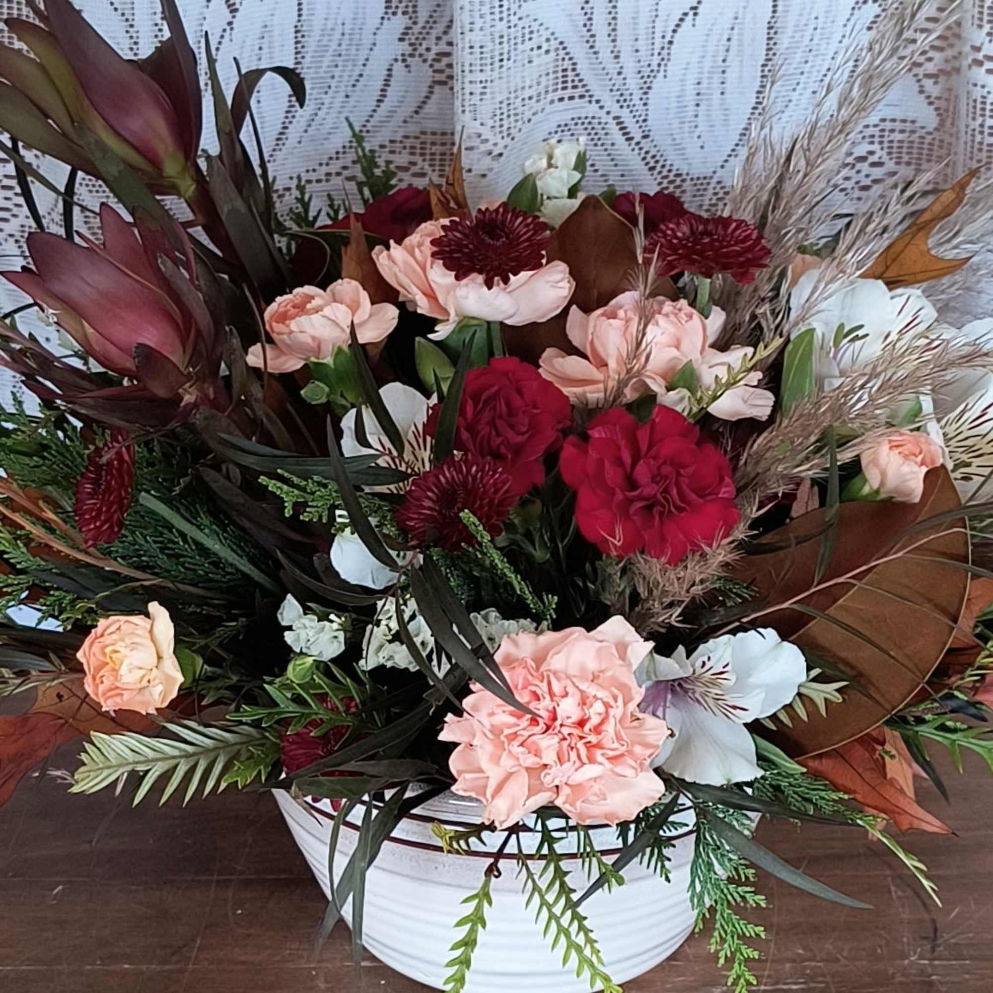 Brighten their day with a Timeless treasured Bouquet, showcasing radiant red and