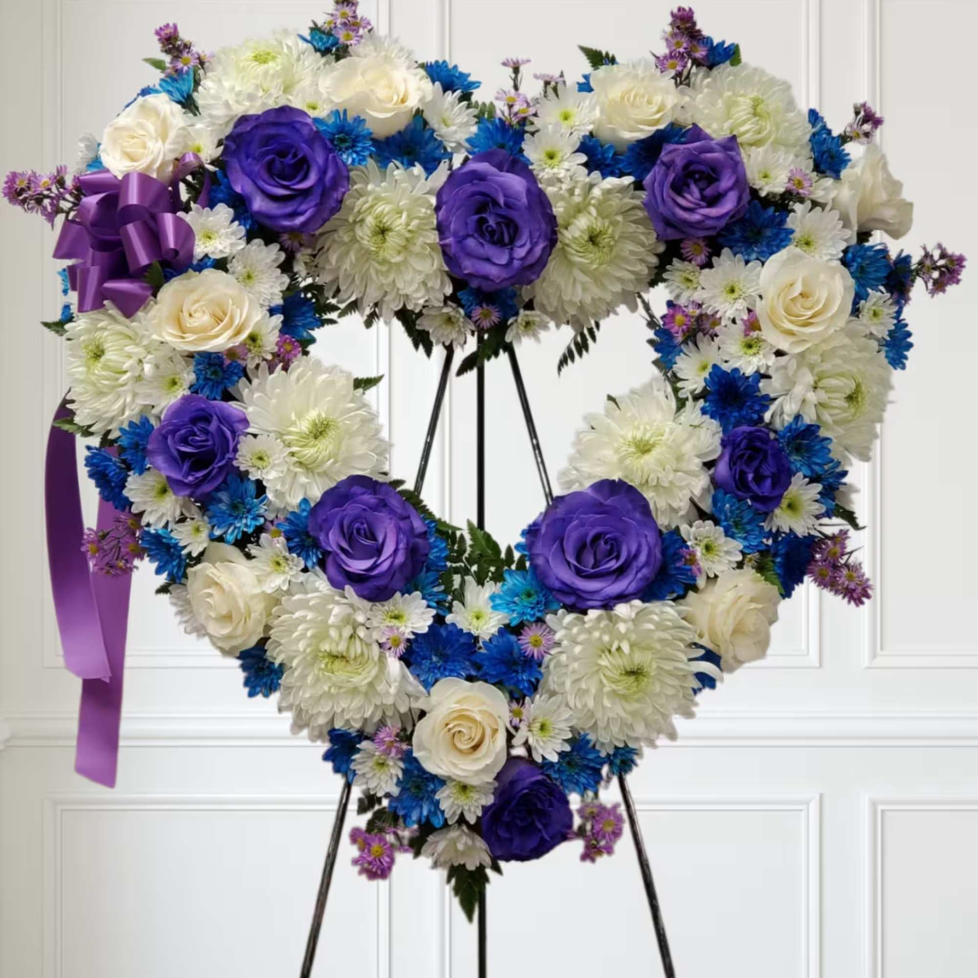 Blue flowers with deep purple roses and white flowers. Blue flowers with deep purple roses and white flowers.