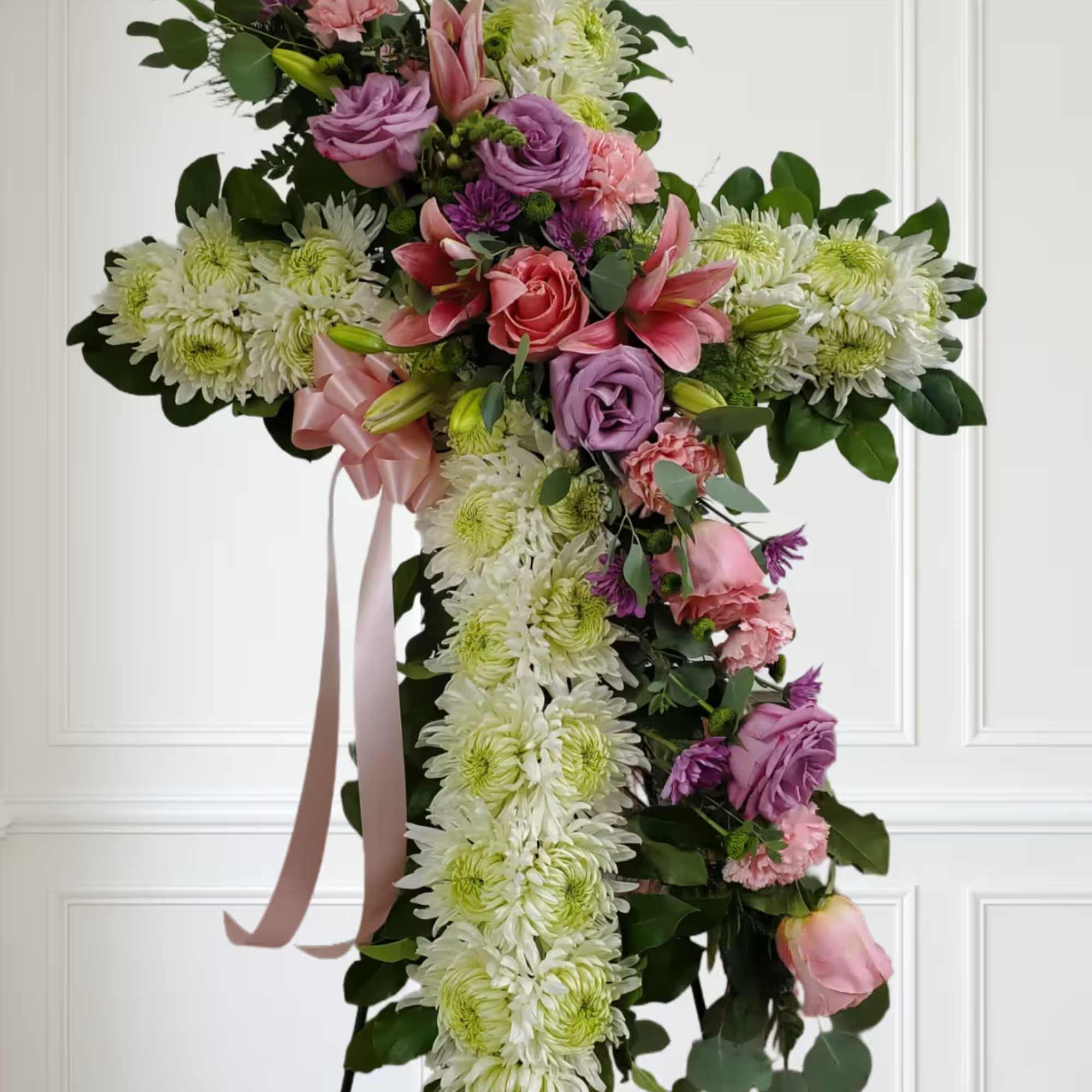 White cross with soft color flowers pinks and purples. White cross with soft color flowers pinks and purples.