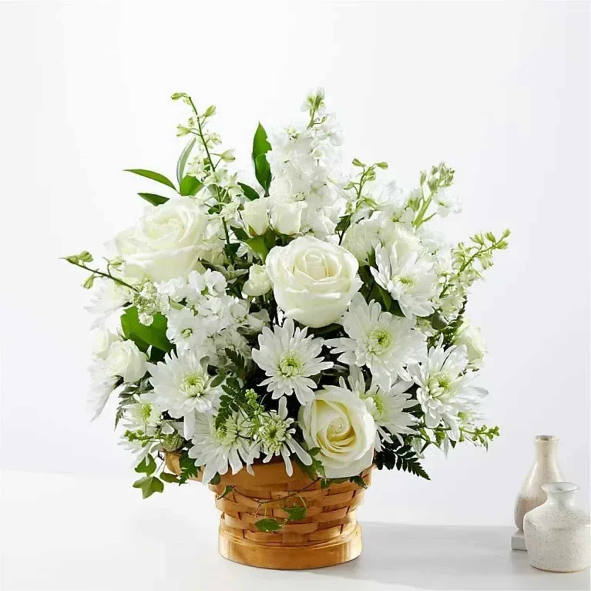Let this exquisite composition of beautiful white blossoms deliver your sympathy and
