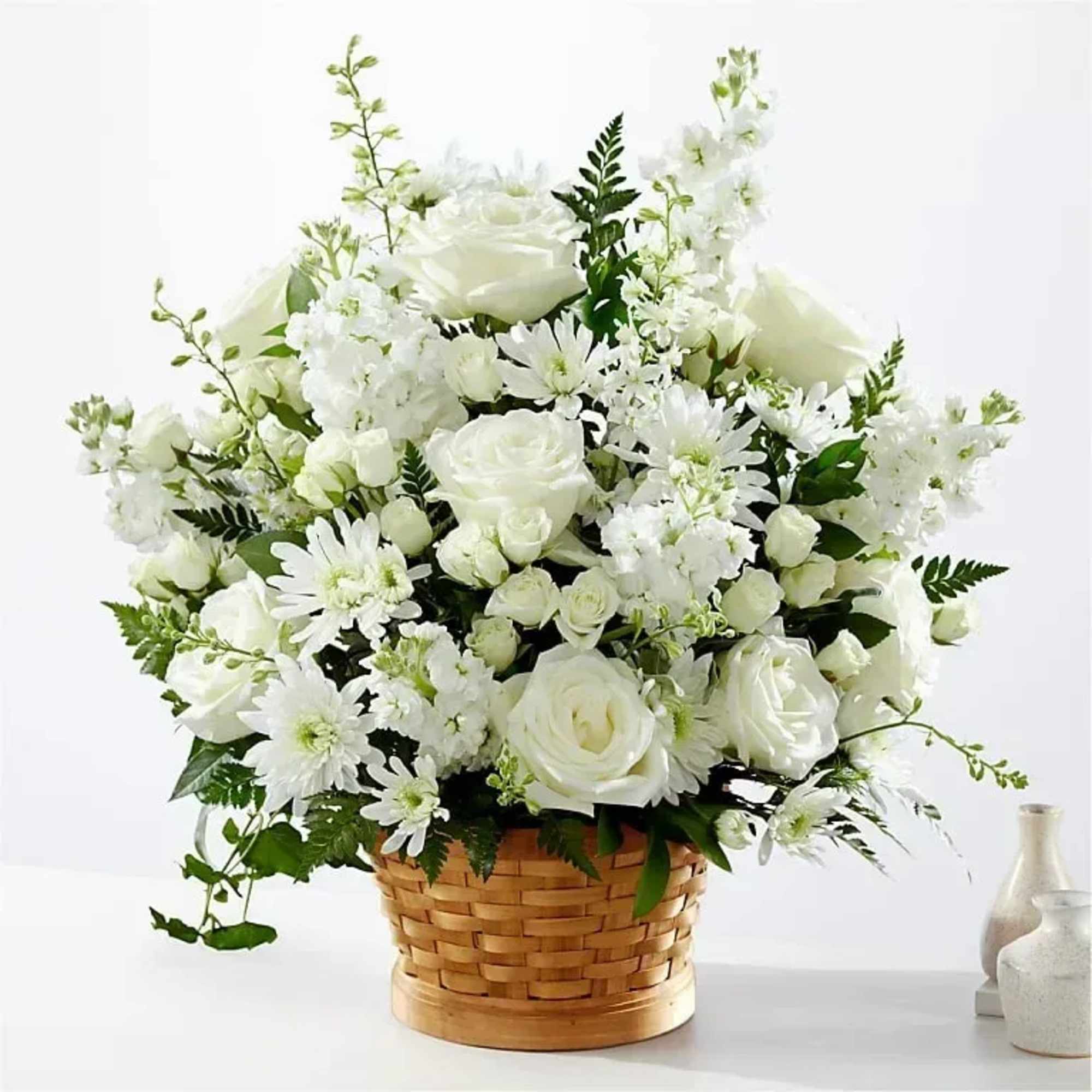 Let this exquisite composition of beautiful white blossoms deliver your sympathy and