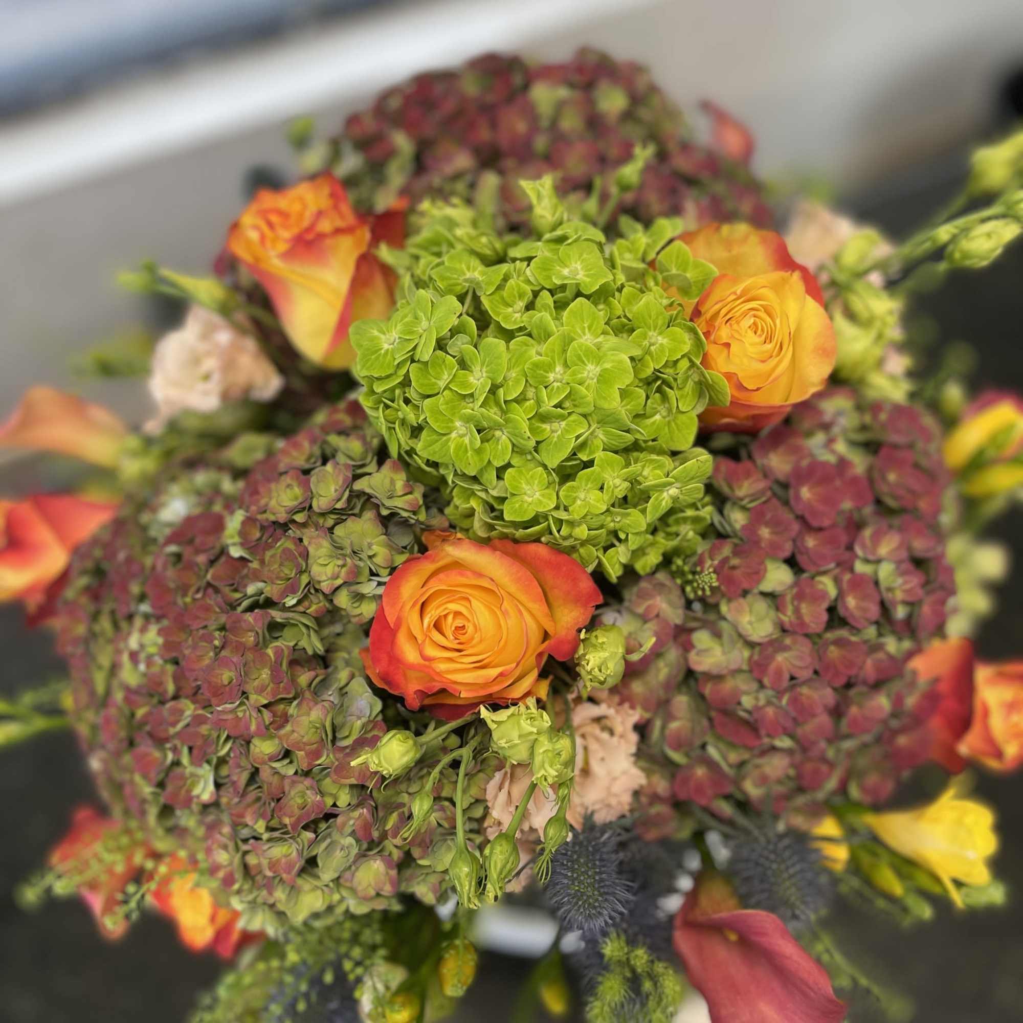 All the Fall colors are featured in this tall arrangment - Standing