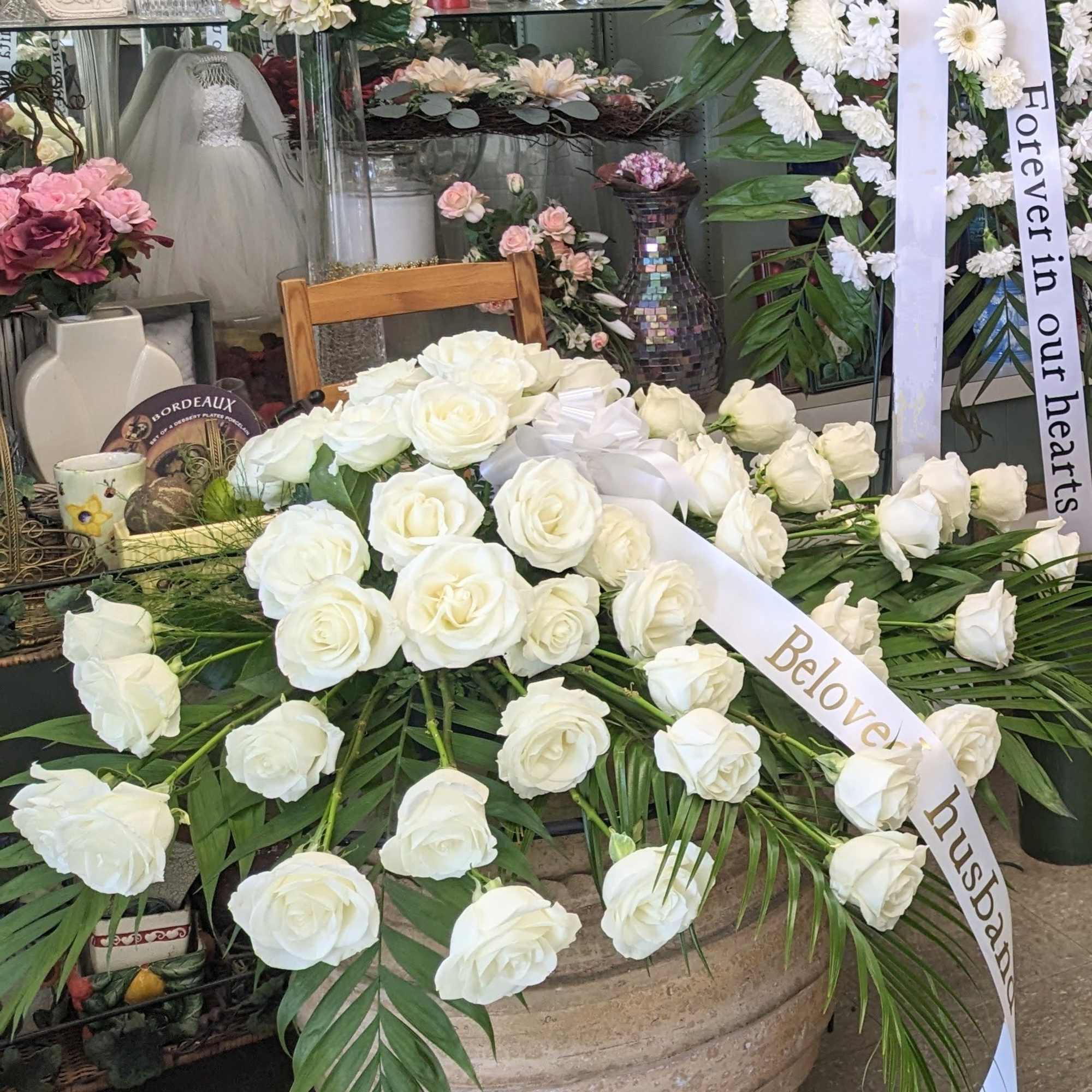 Red roses or White Rose in this full casket symbolize love and