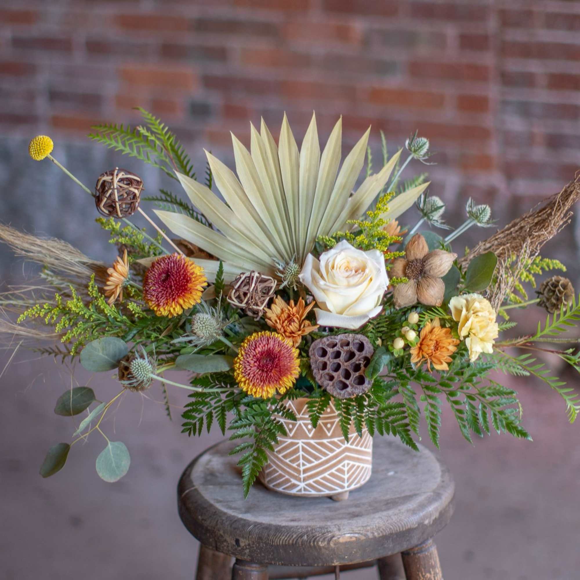 A perfect medley of fresh and dried floral materials artfully arranged in