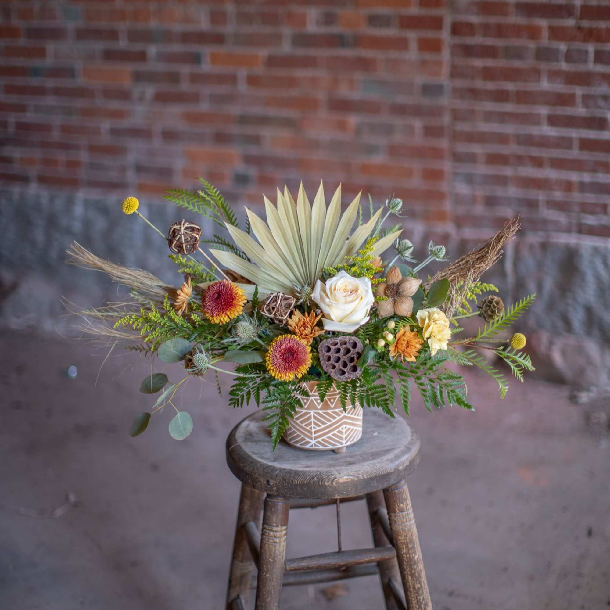 A perfect medley of fresh and dried floral materials artfully arranged in