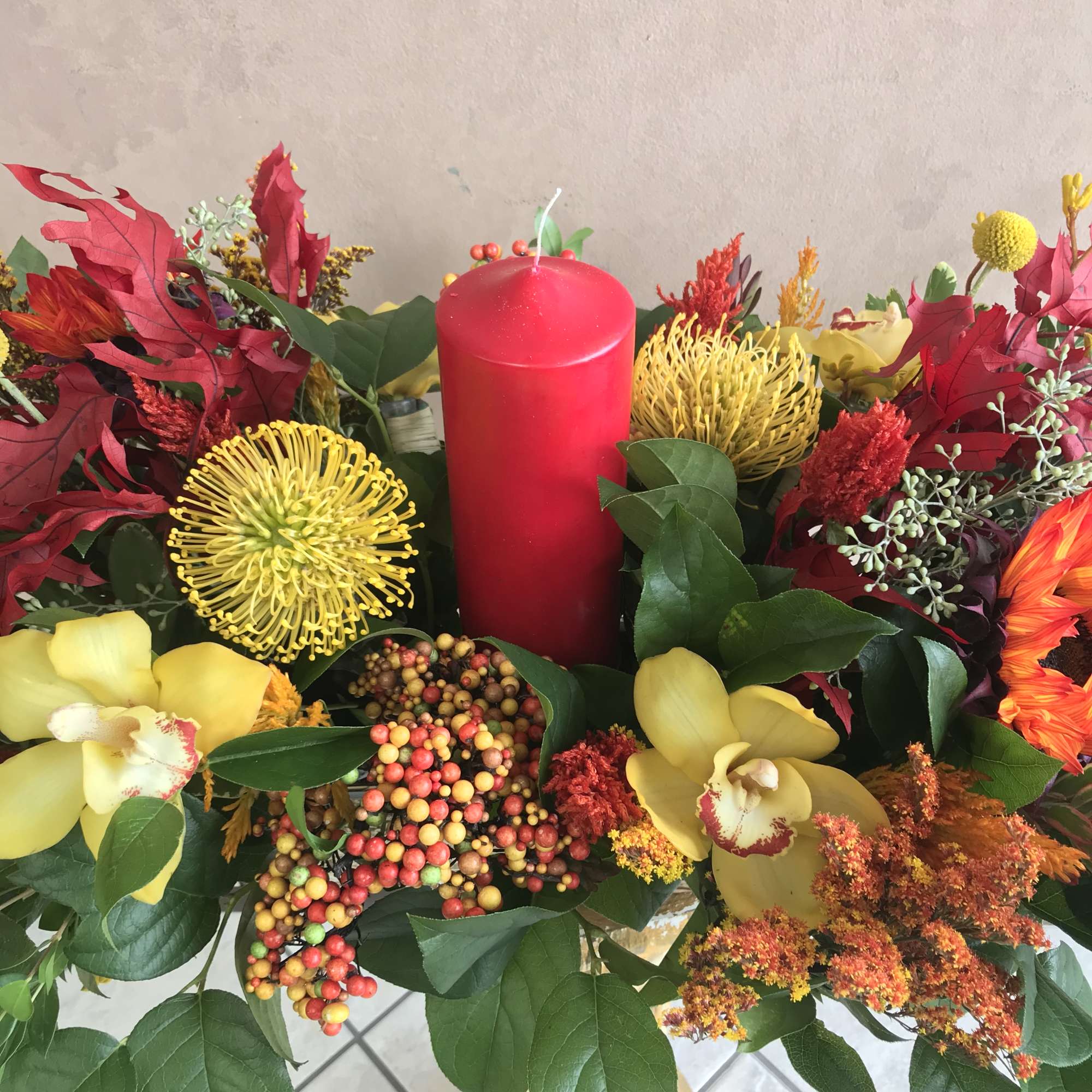 Thanksgiving centerpiece featuring an assortment of fall flowers arranged in a floral