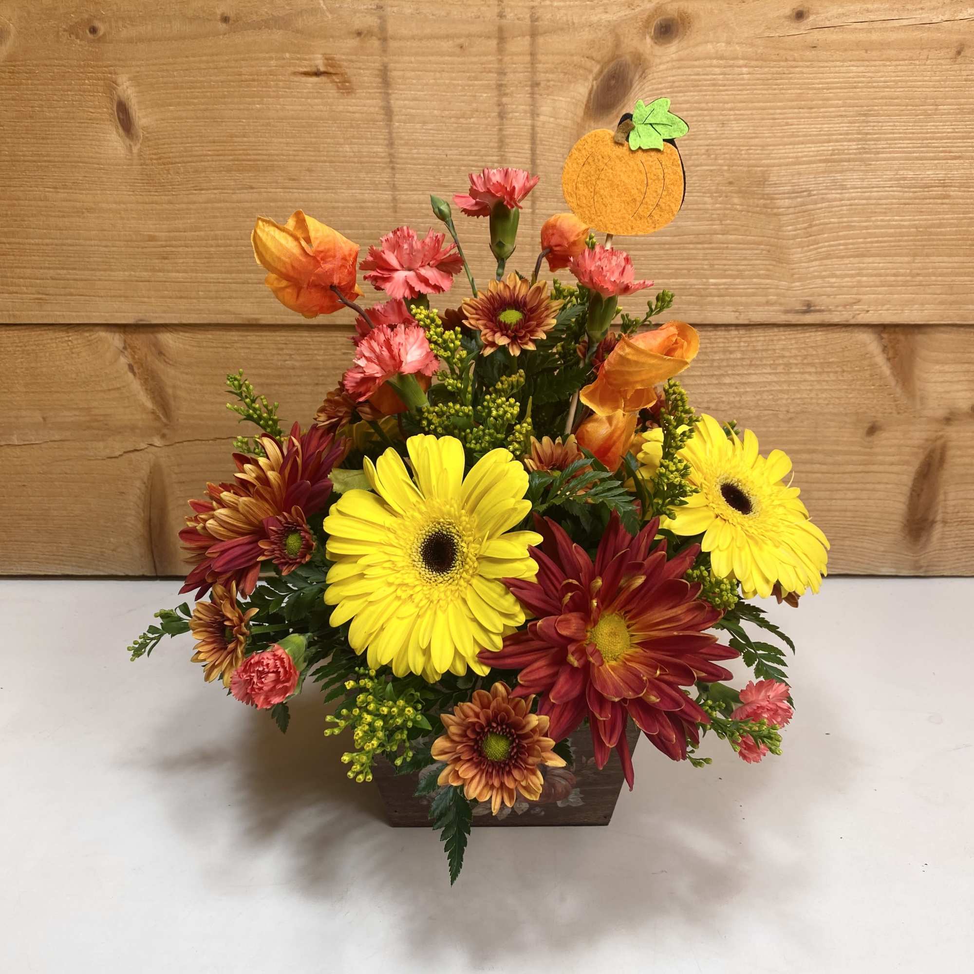 Rustic Harvest is a delightful arrangement with gerbera daisies, mini carnations, and