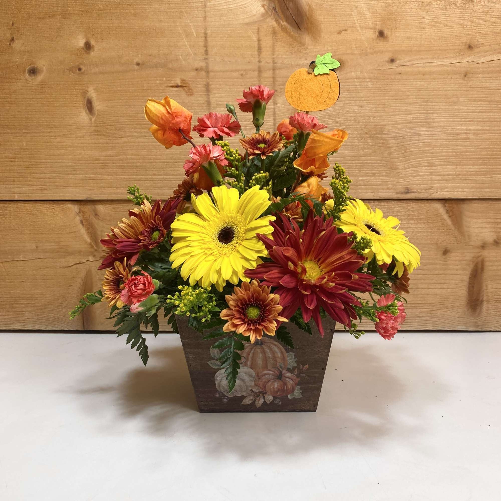 Rustic Harvest is a delightful arrangement with gerbera daisies, mini carnations, and
