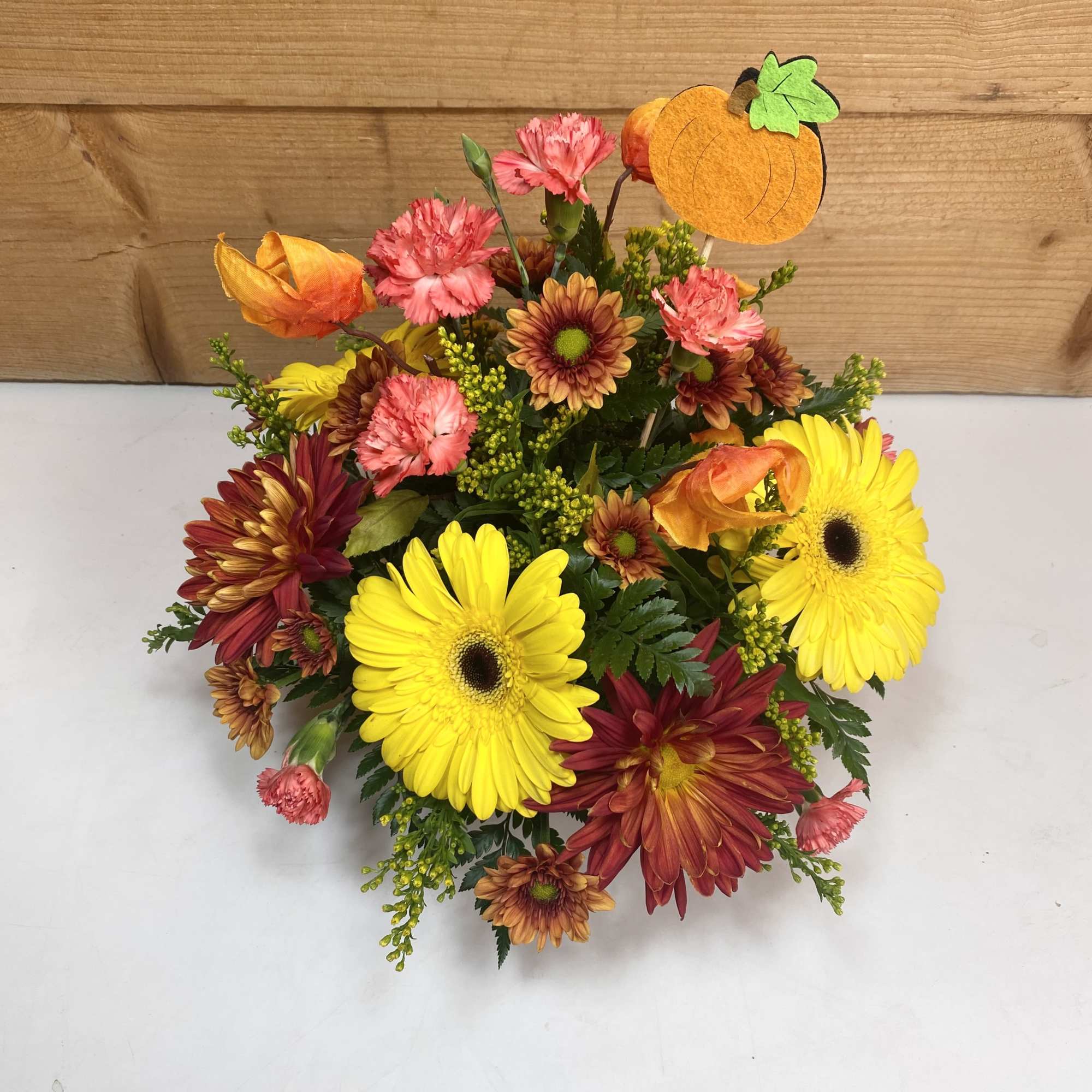 Rustic Harvest is a delightful arrangement with gerbera daisies, mini carnations, and