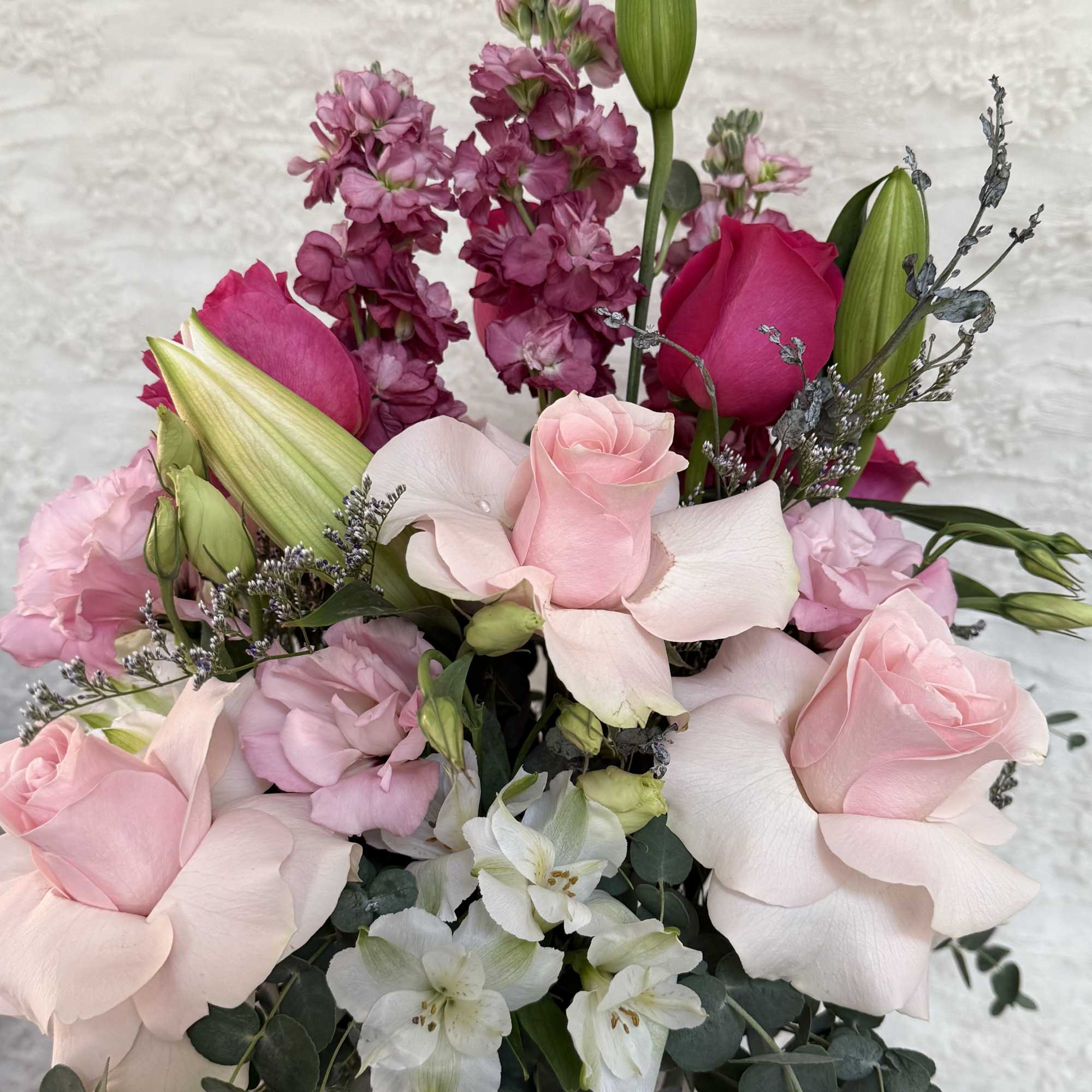 Tall arrangement filled with Lillies, light and hot pink roses, Alstroemeria and