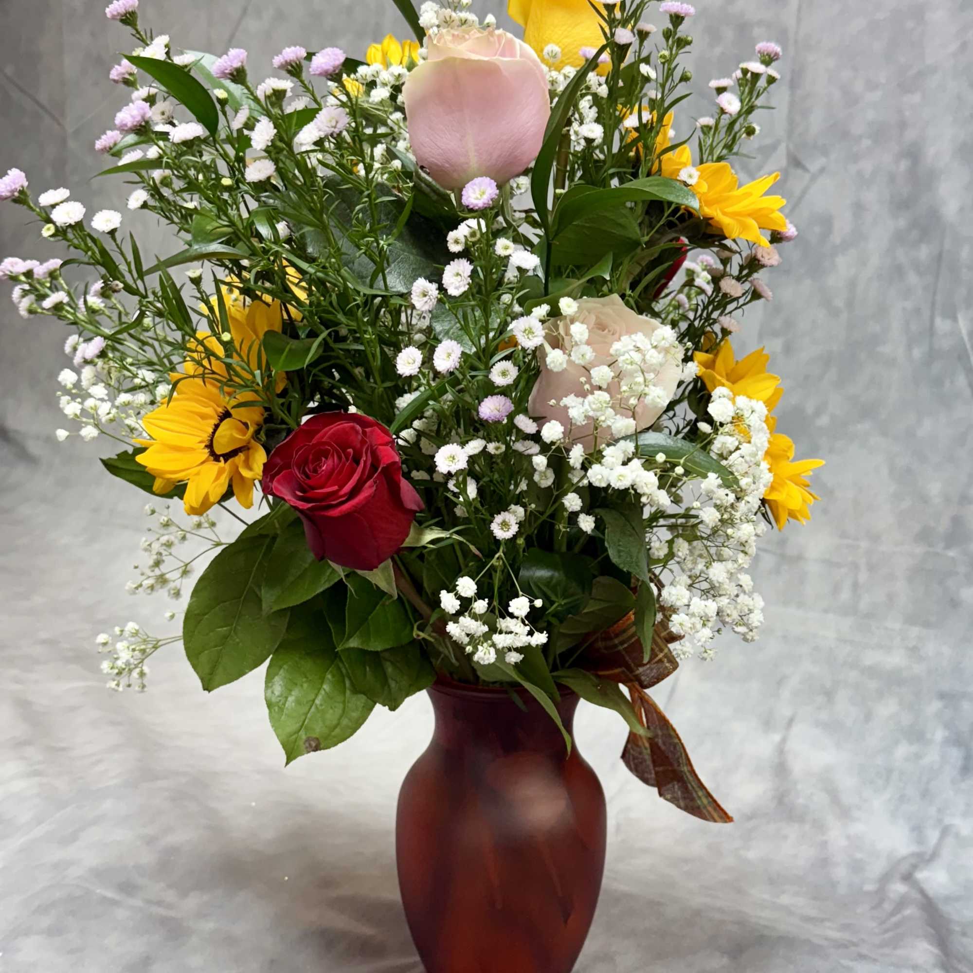 Introducing our vibrant sunflower and rose vase, a perfect blend of warmth