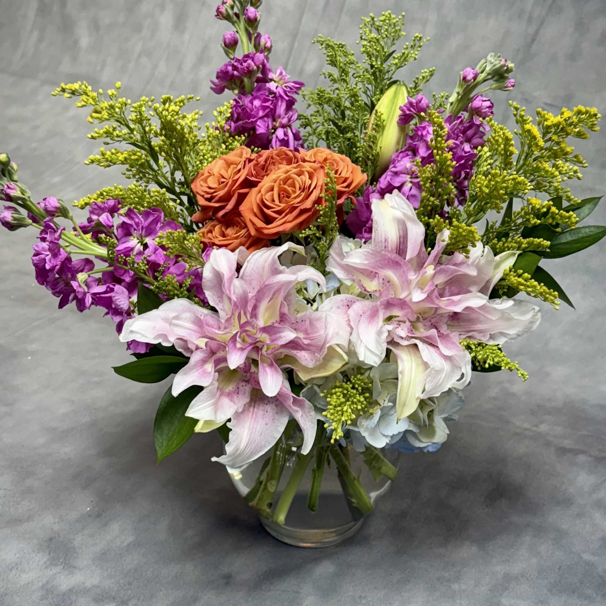Flamingo Sunset is a vibrant floral arrangement bursting with warmth and elegance.