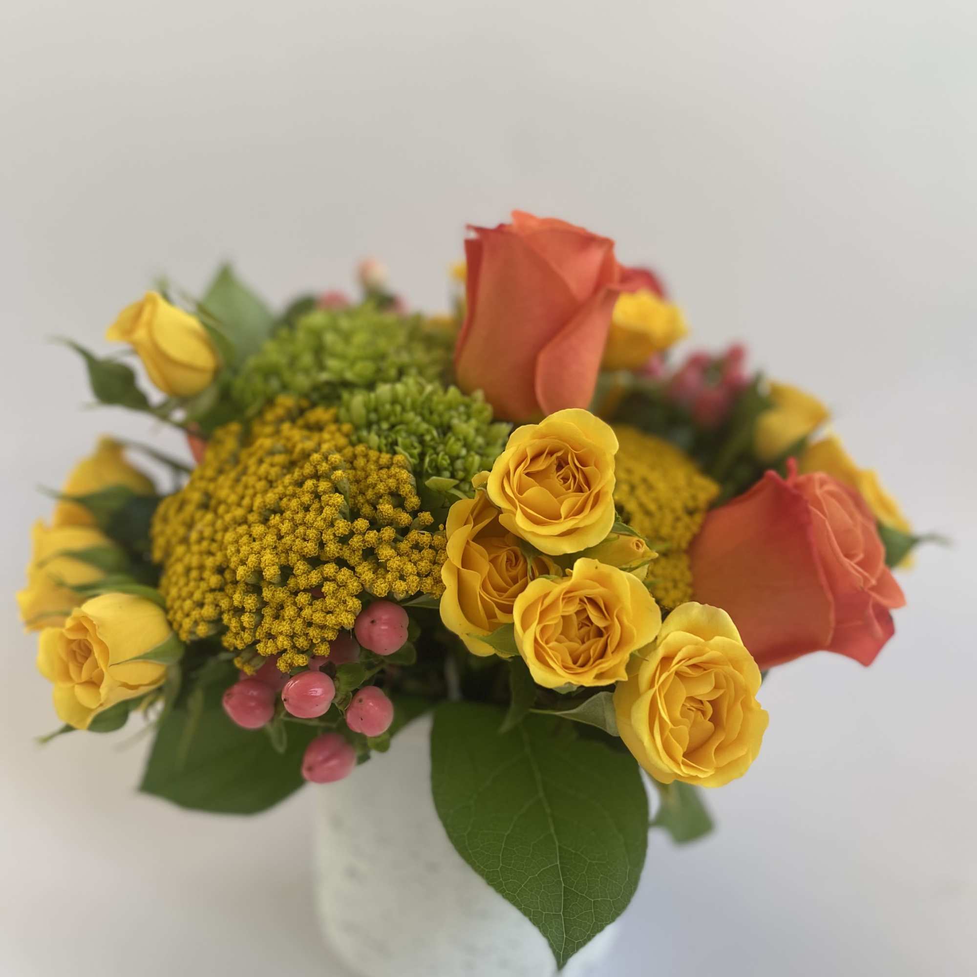 Oranges, yellows and greens. Crisp &amp; clean. Hydrangeas, roses, berries, and yarrow