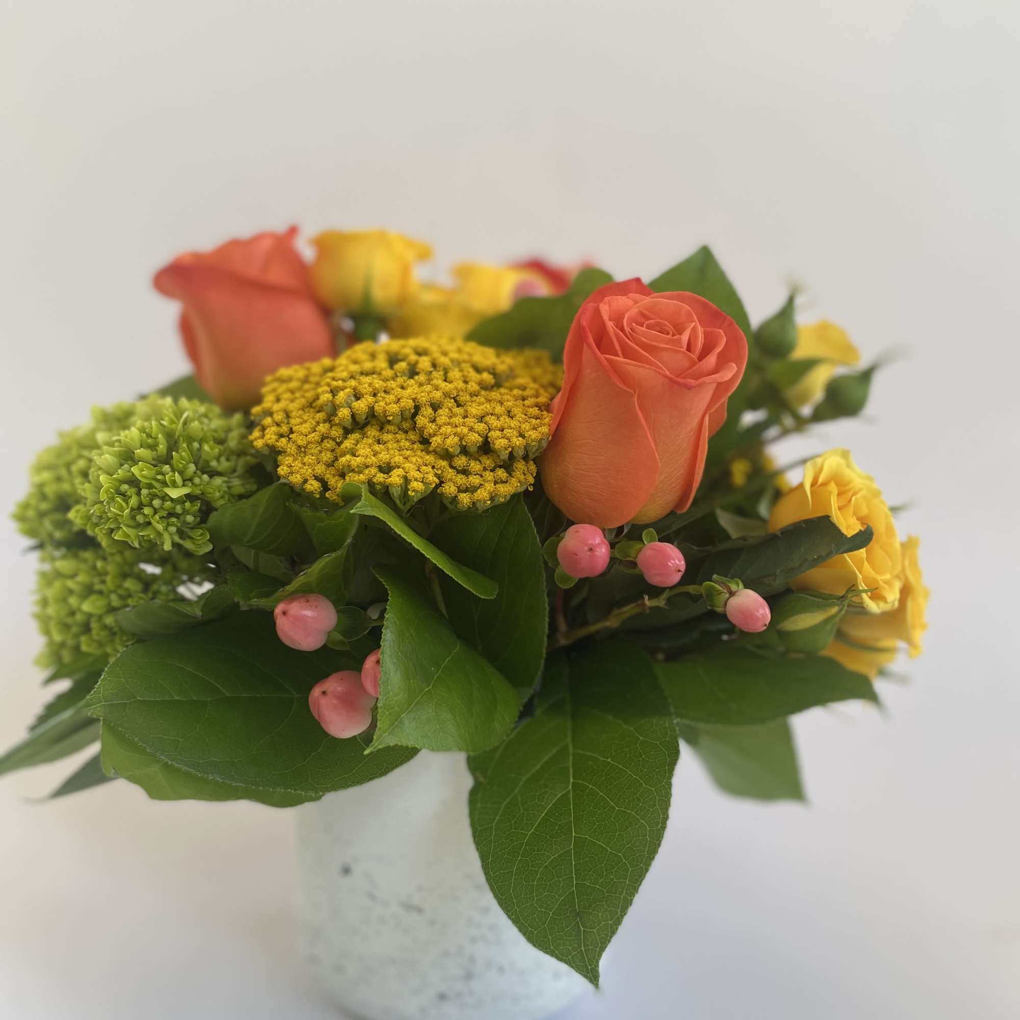 Oranges, yellows and greens. Crisp &amp; clean. Hydrangeas, roses, berries, and yarrow