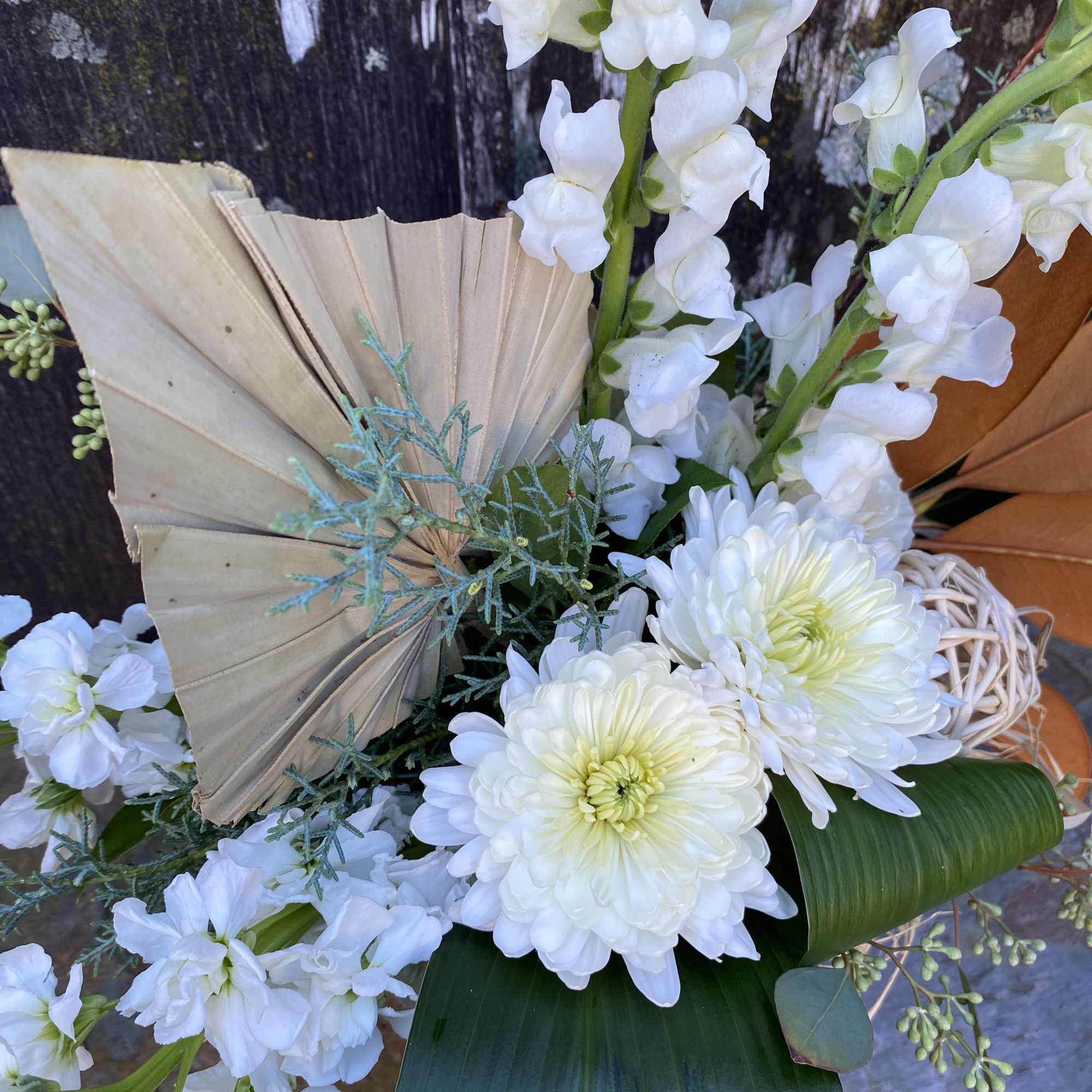 Soft tones of autumn transitioning to winter created with fresh flowers, greenery