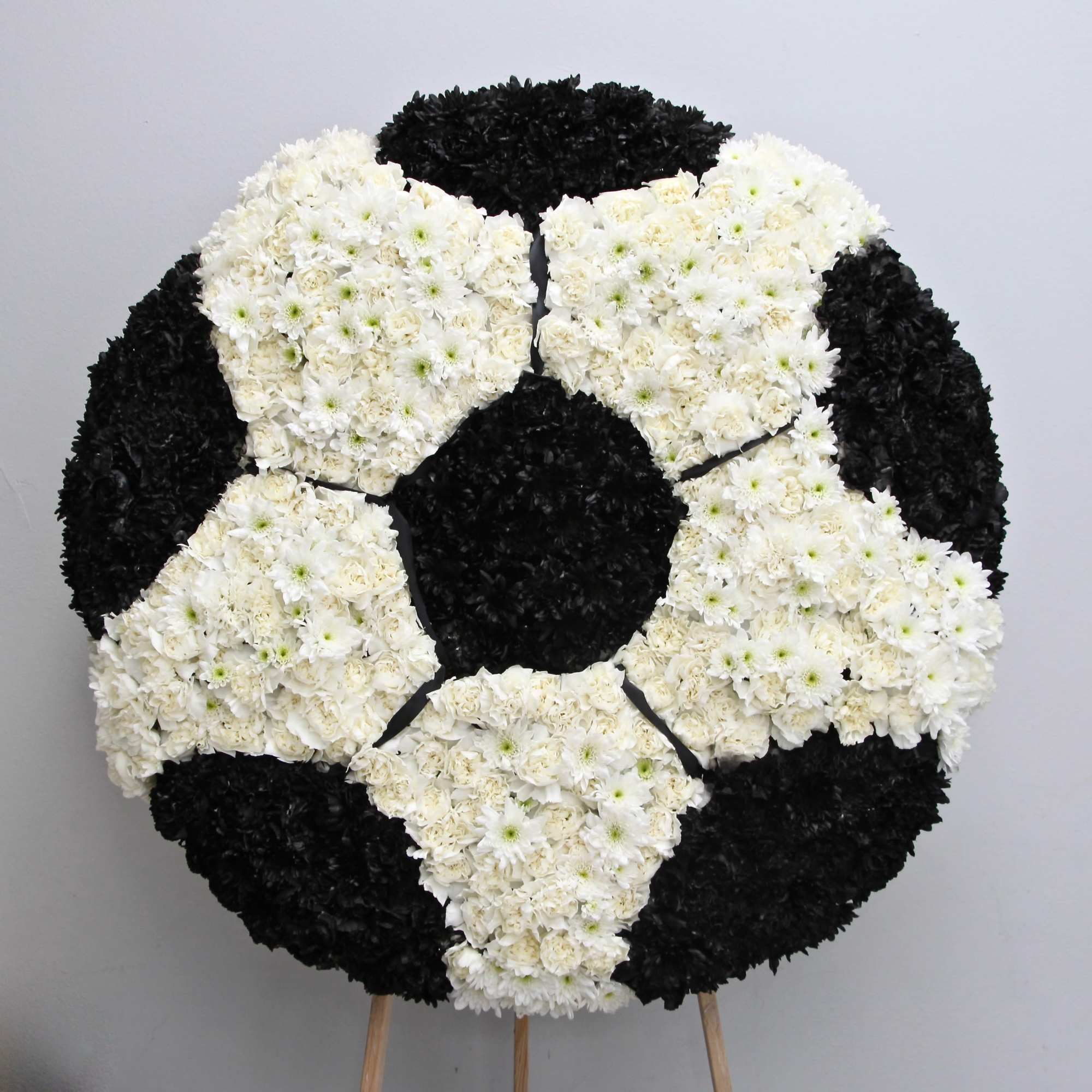 This full wreath contains custom flowers . The standard size is approximately
