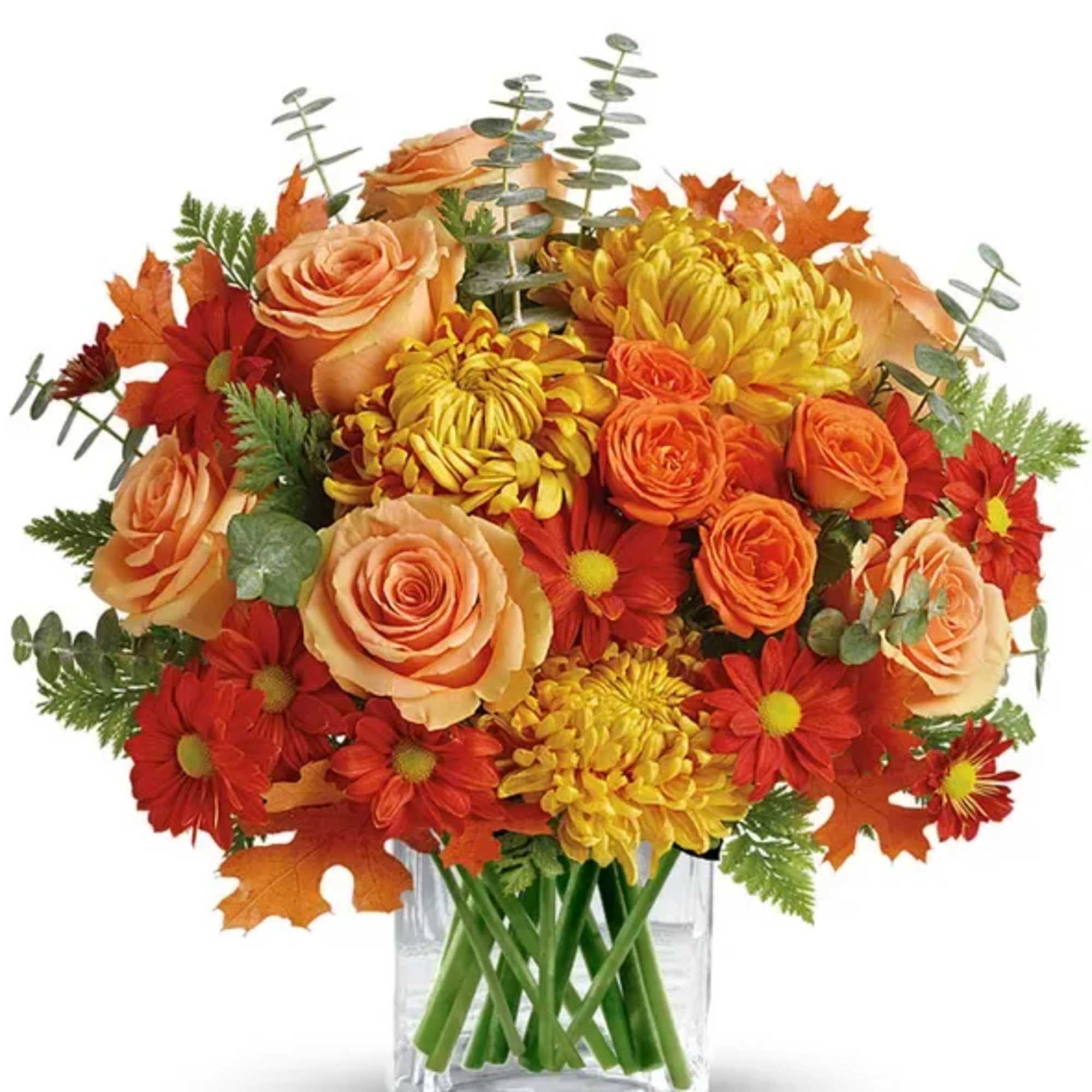 Beatiful fall arangment in a cube vase with some orange roses and