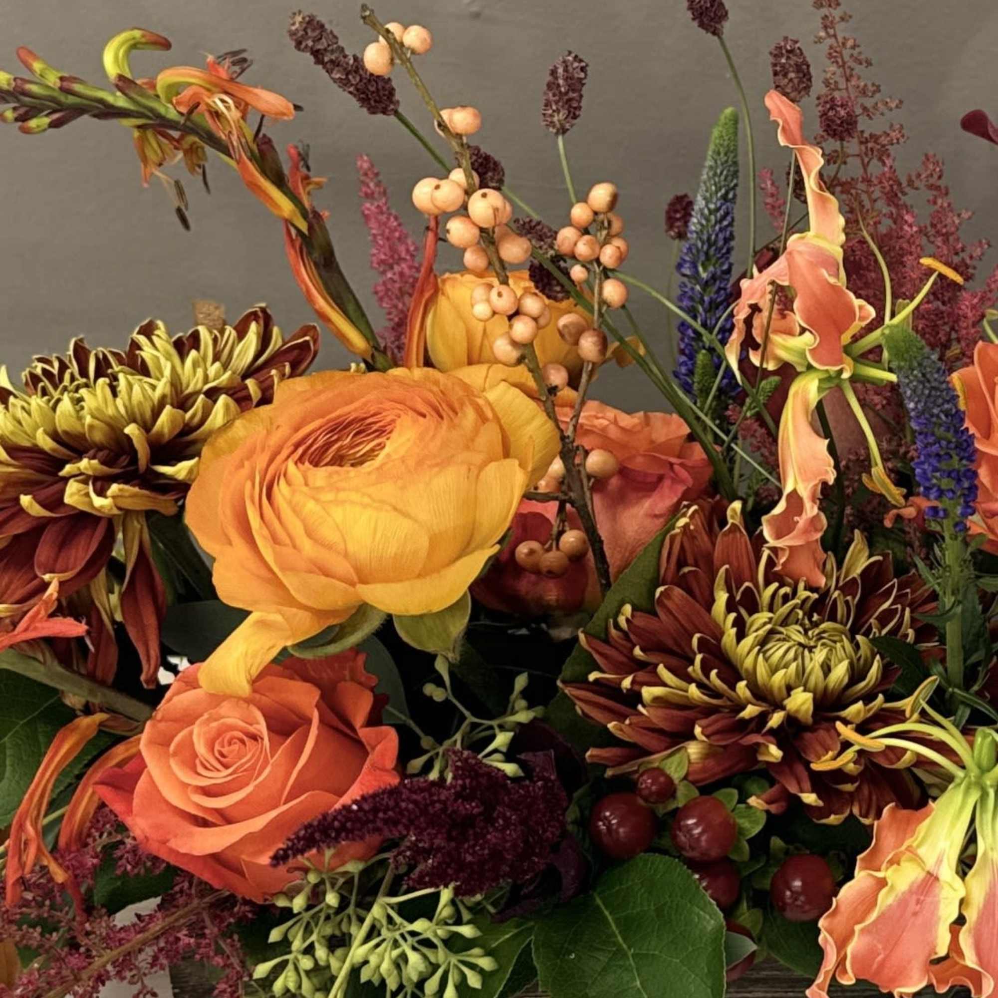 A low rectangle centerpiece created in a wooden box filled with textures