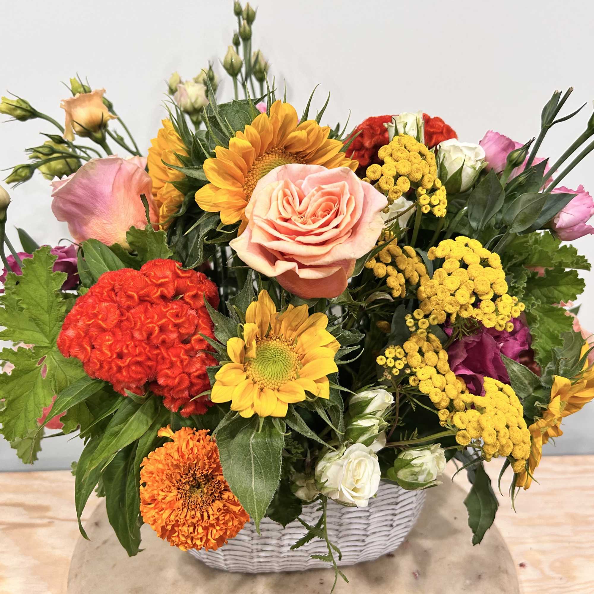 A ceramic basket is used as the base of this arrangement. The
