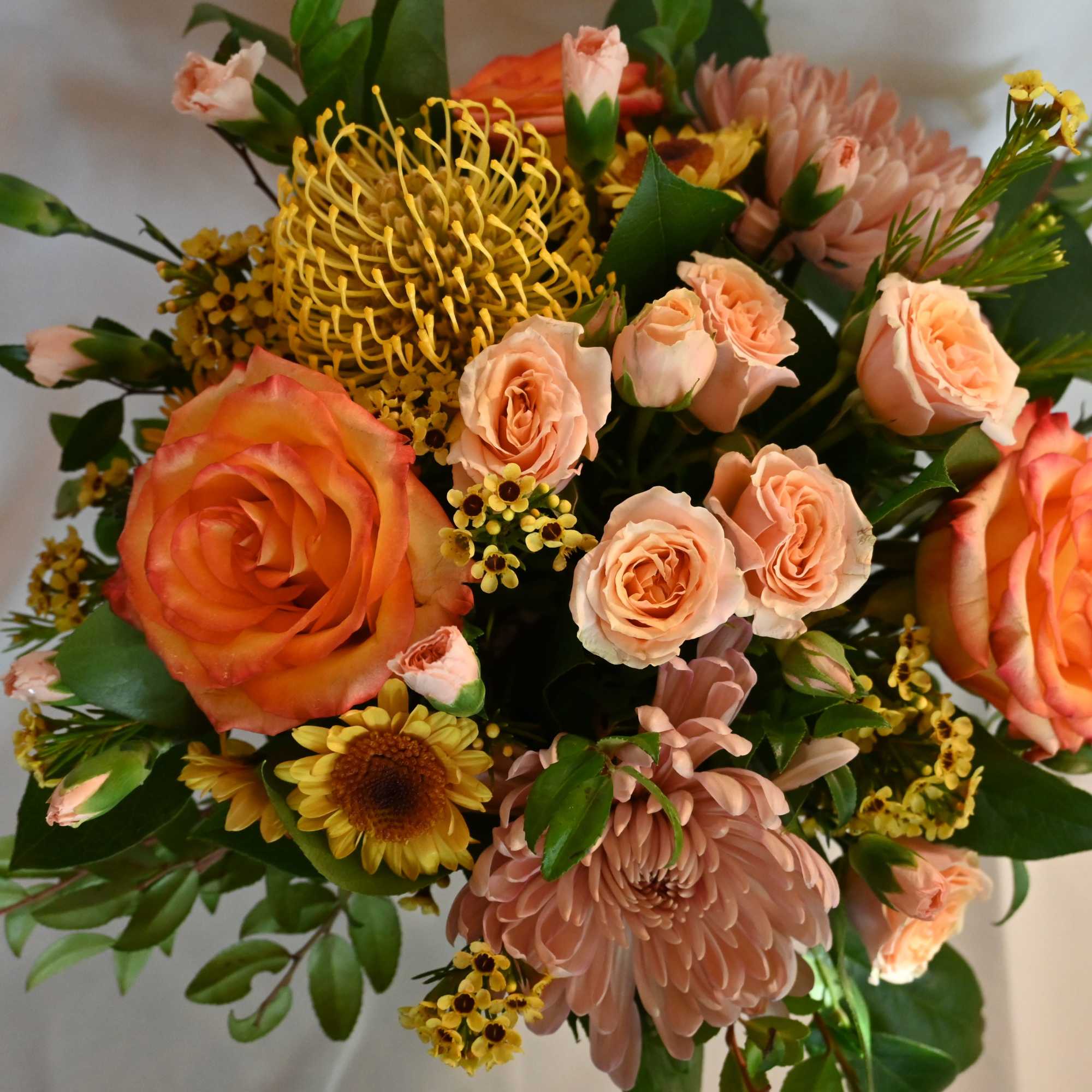 Celebrate the season with our Standard holiday centerpiece. Featuring seasonal blooms arranged