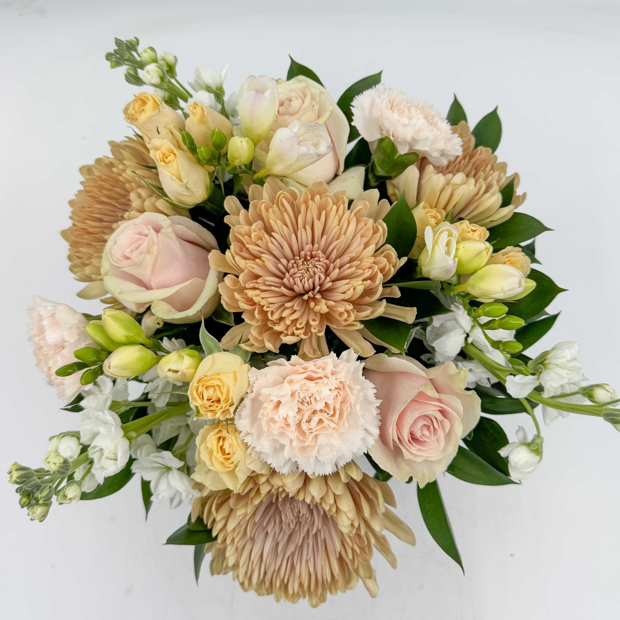 Maman features Peach Chrysanthemums, Blush Roses, Peach Spray Roses, White Stock, White