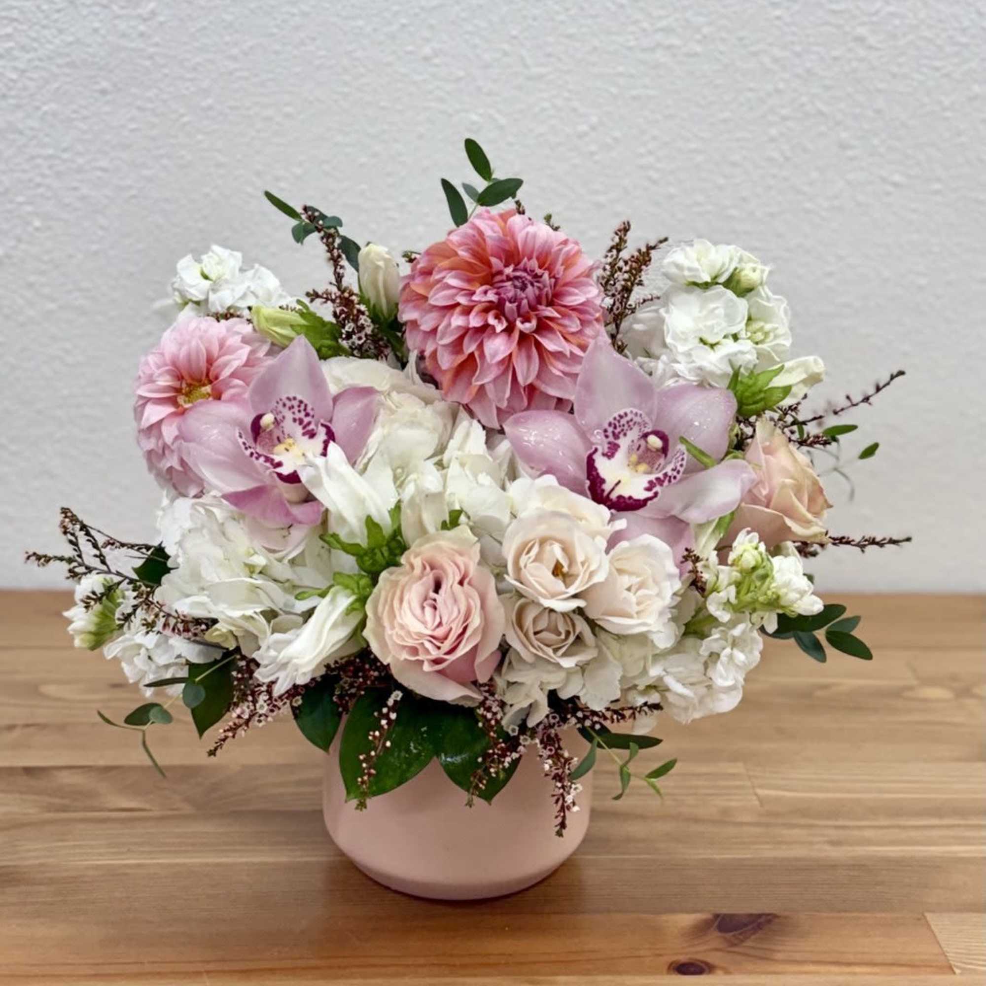 This stunning pastel pink arrangement, elegantly displayed in a pink Kendall vase