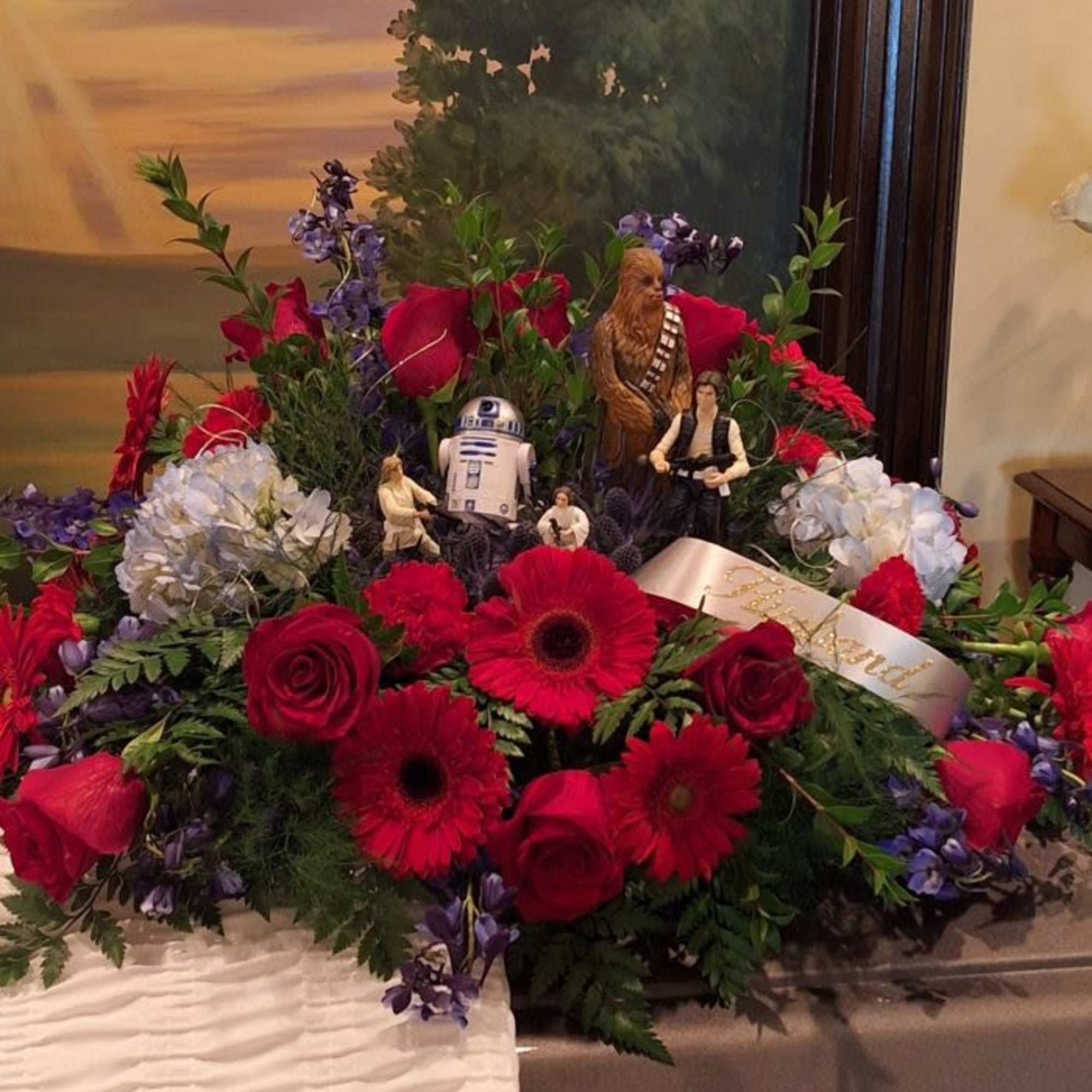 We do themed casket sprays. 
Contact us for more information.