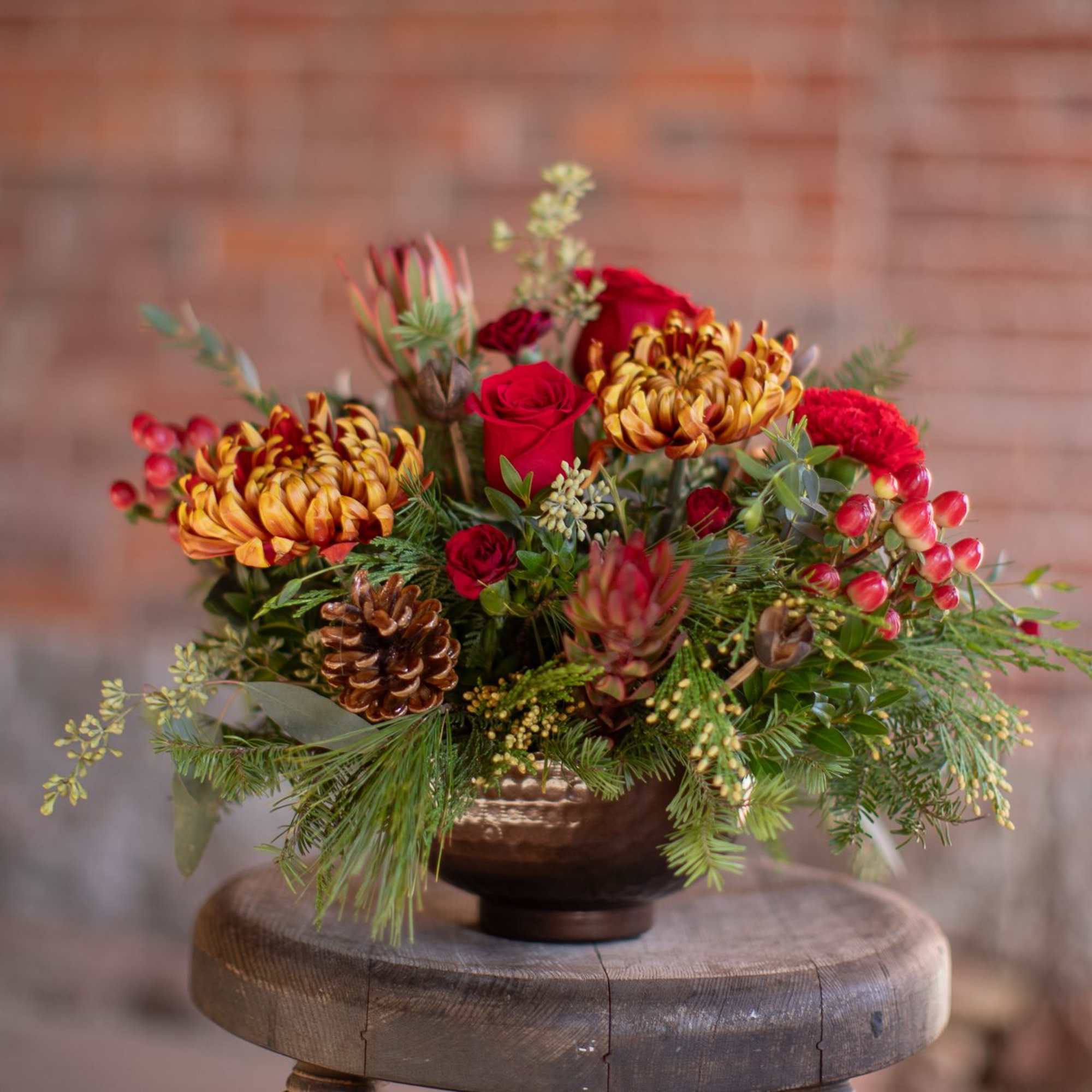 In the center of this brassy-bronze metal compote style dish is a
