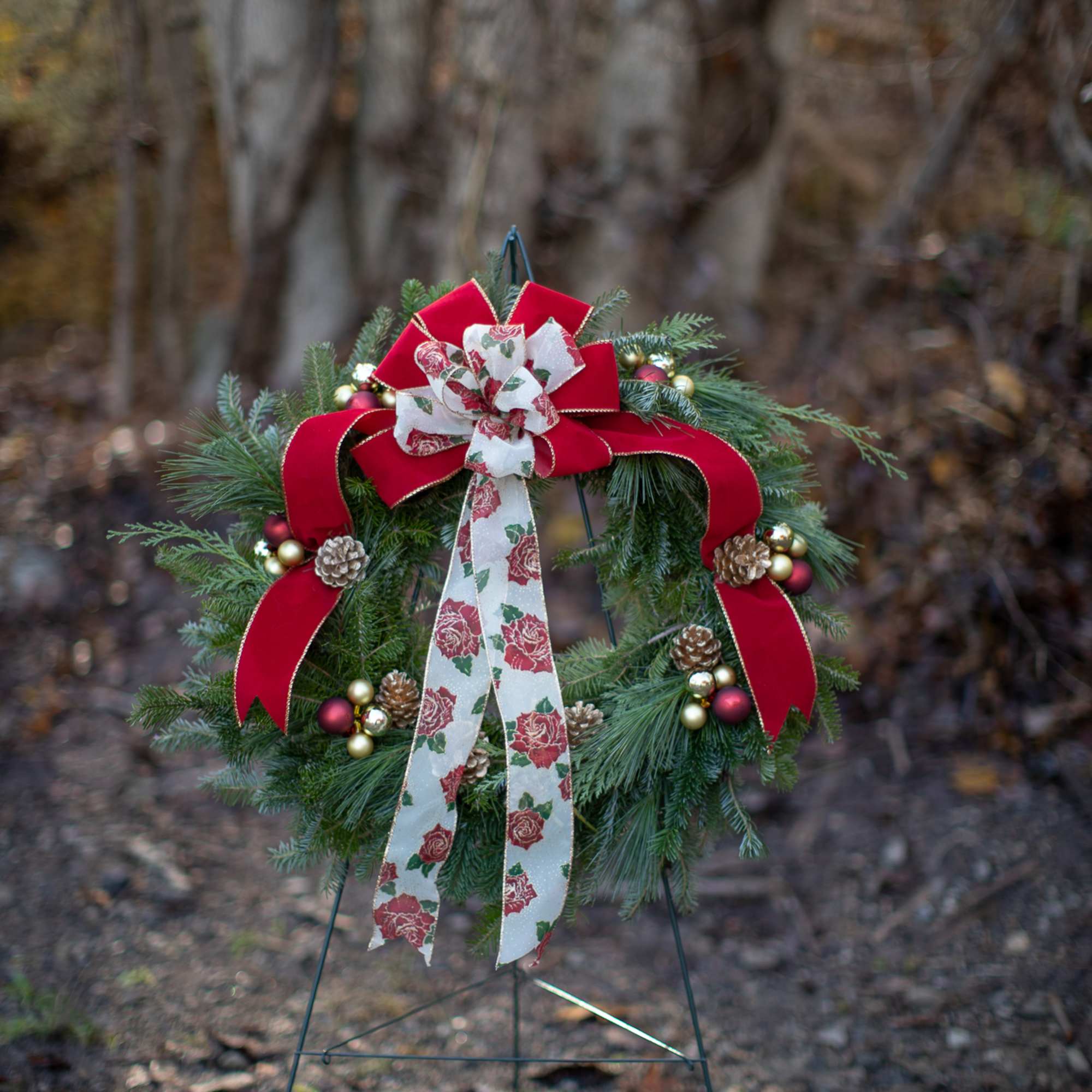 Fragrant fresh balsam wreath decorated with cones, ornaments, winter trimmings, bows, berries