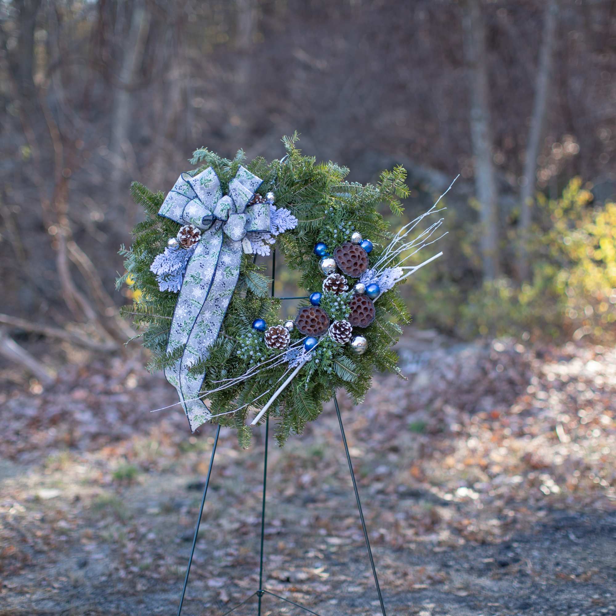 Fragrant fresh balsam wreath decorated with cones, ornaments, winter trimmings, bows, berries
