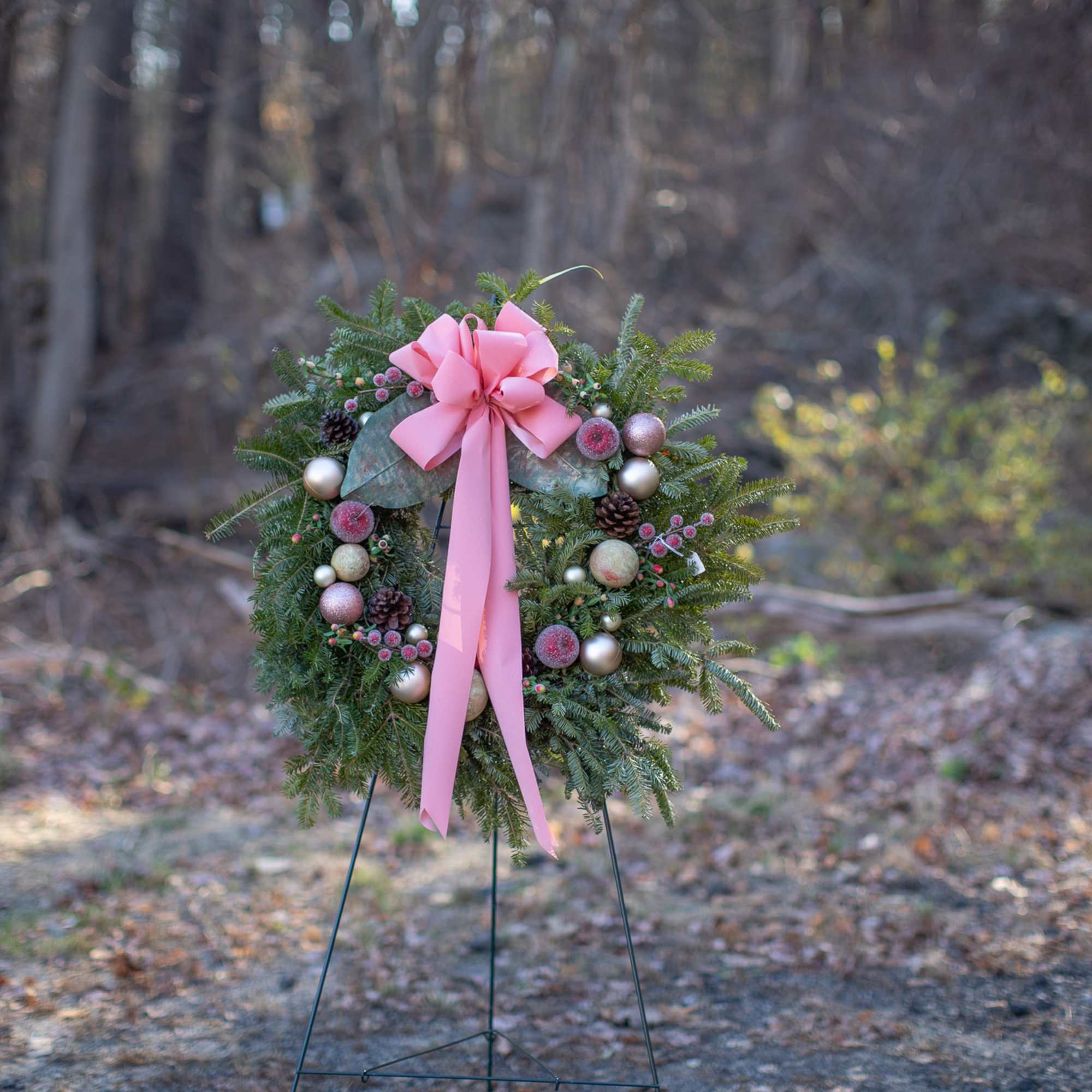 Fragrant fresh balsam wreath decorated with cones, ornaments, winter trimmings, bows, berries