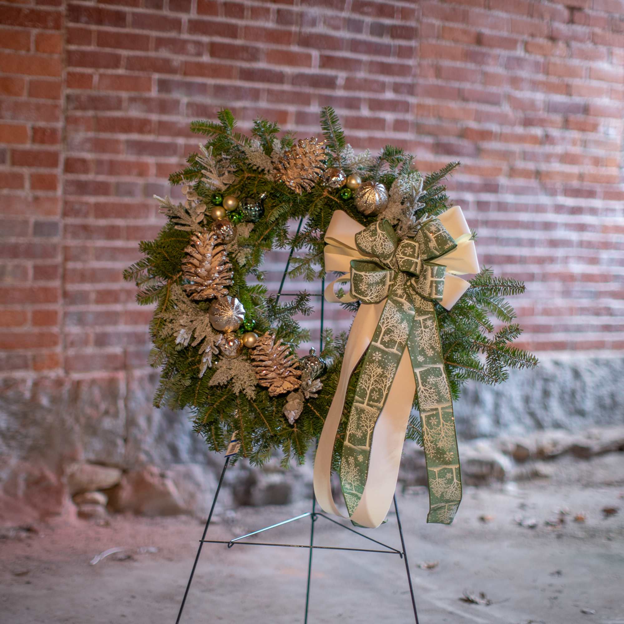 Fragrant fresh balsam wreath decorated with cones, ornaments, winter trimmings, bows, berries