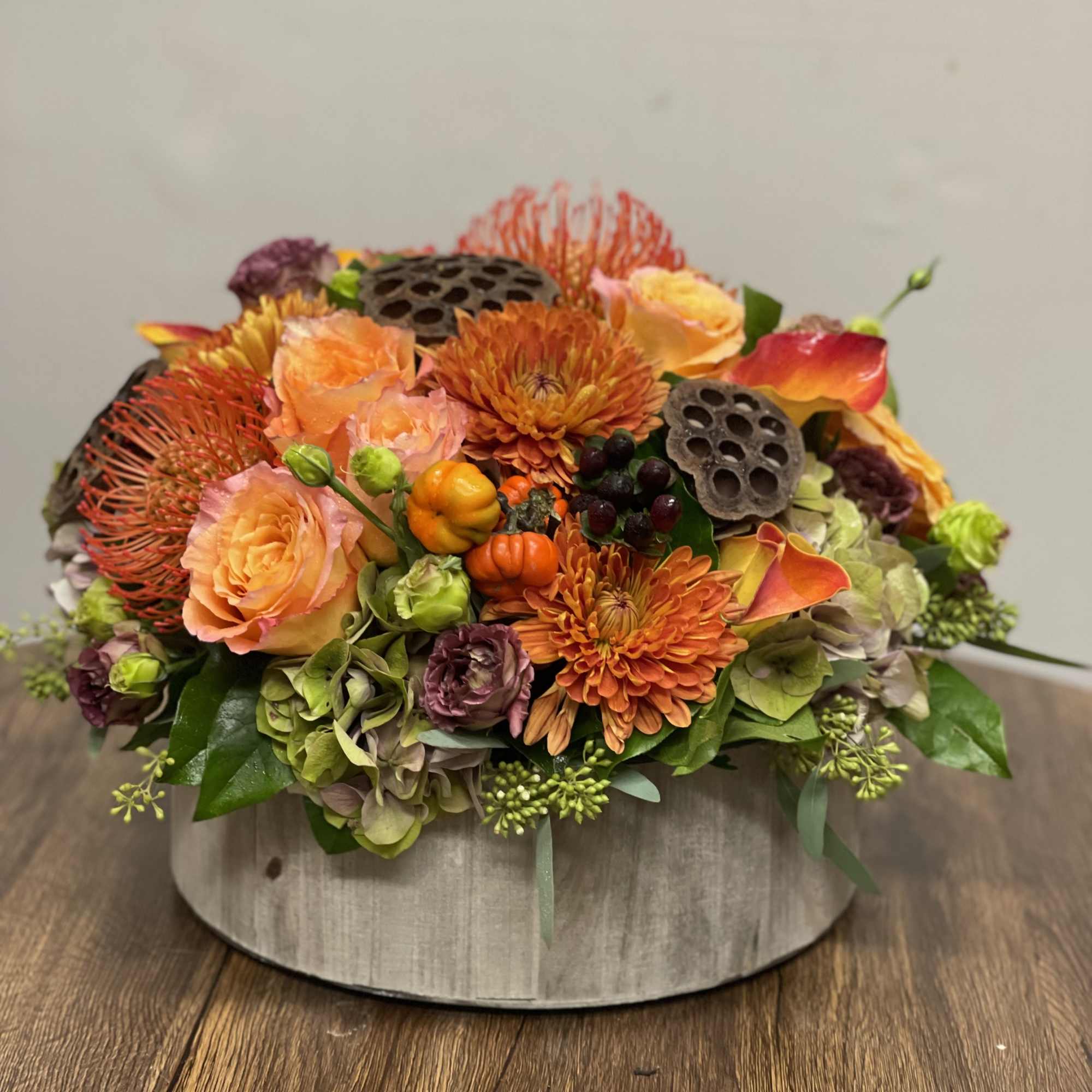 Beautiful combination of Fall flowers including Roses, Hydrangeas, Lisianthus, Protea, Calla and