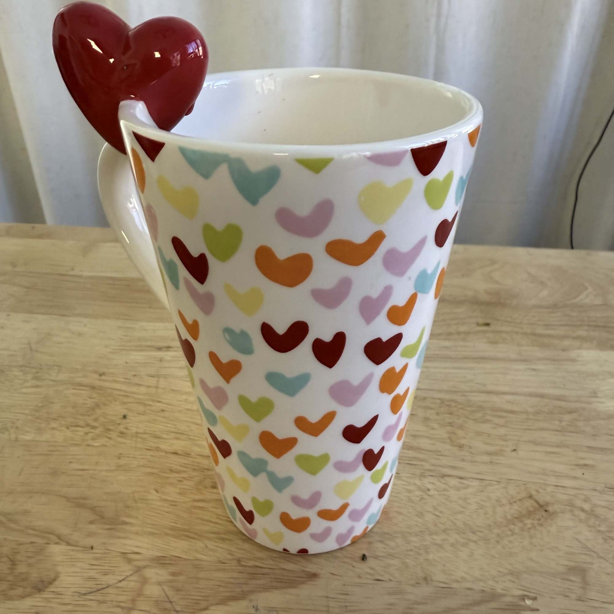 A delicate arrangement featuring soft pink roses, daisies, and wildflower accents in