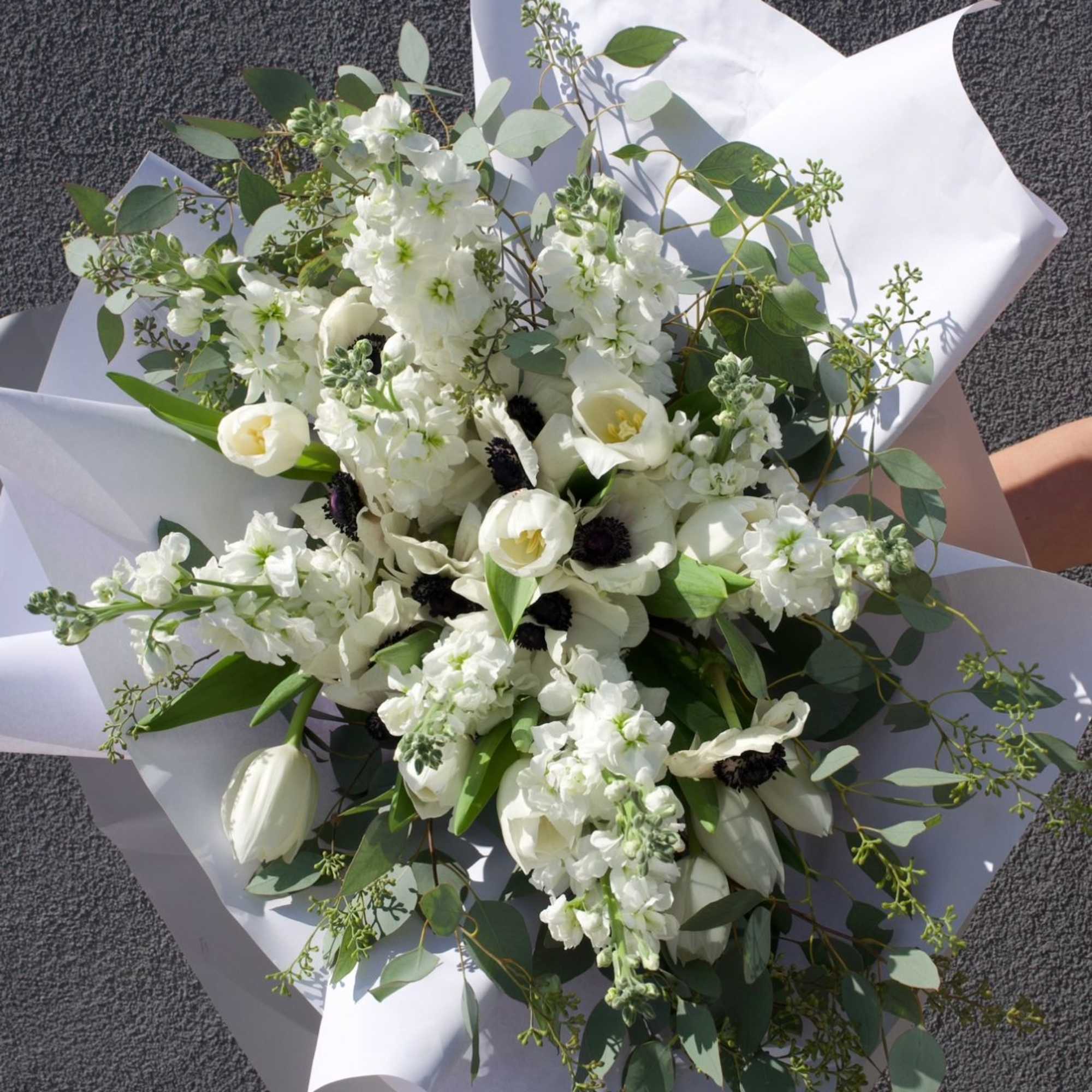 A symphony of white and shadow, this bouquet evokes the quiet drama