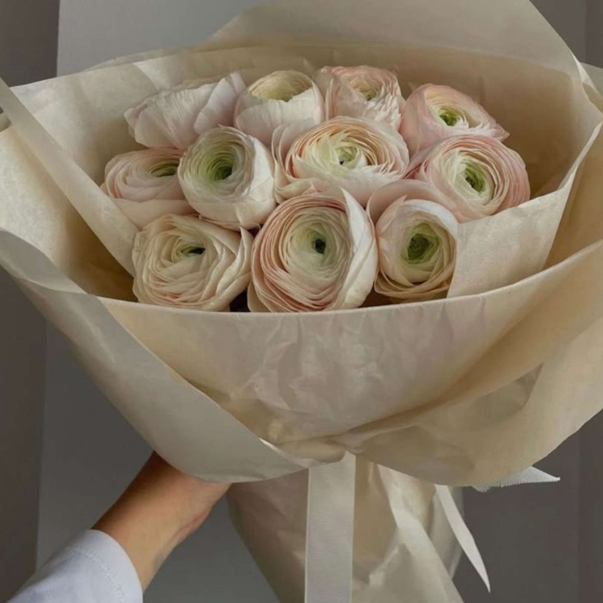 Soft-spoken elegance. A bouquet of premium blush ranunculus wrapped in muted ivory