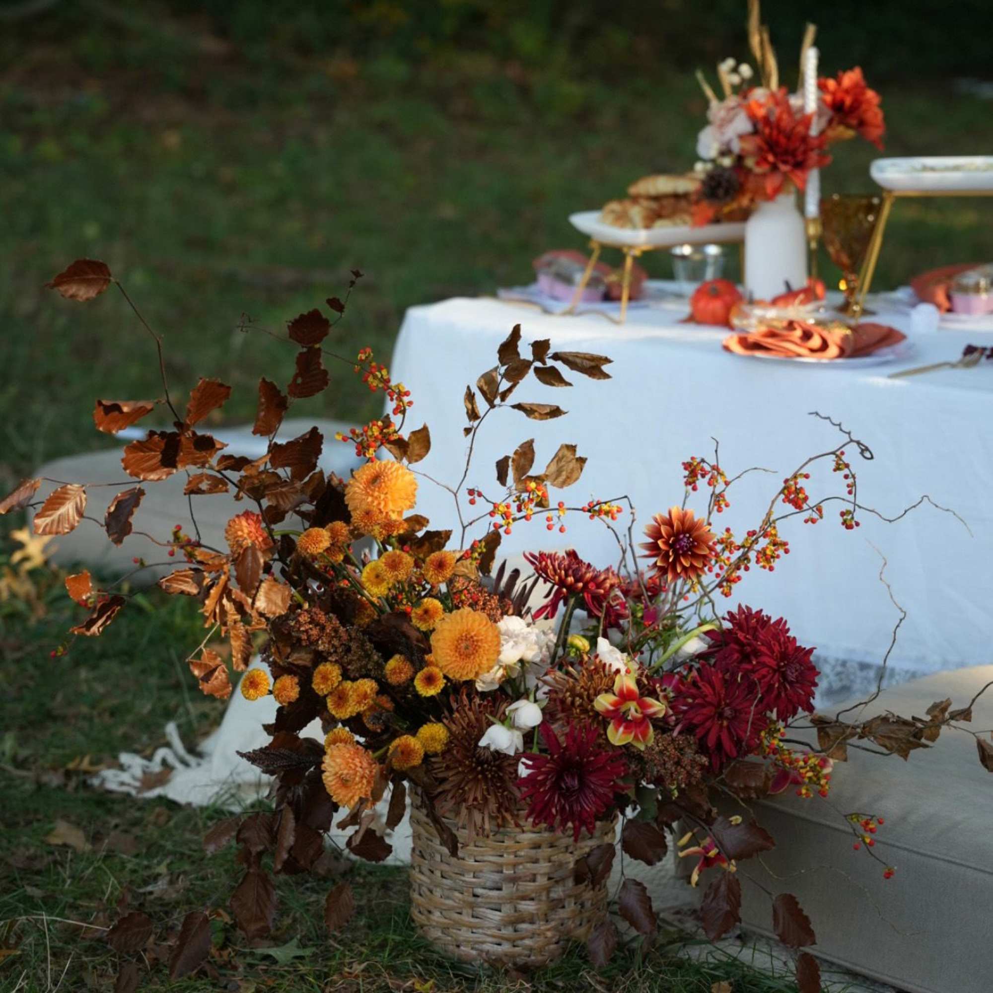 A beautiful fall-inspired basket arrangement featuring seasonal flowers in deep wine and