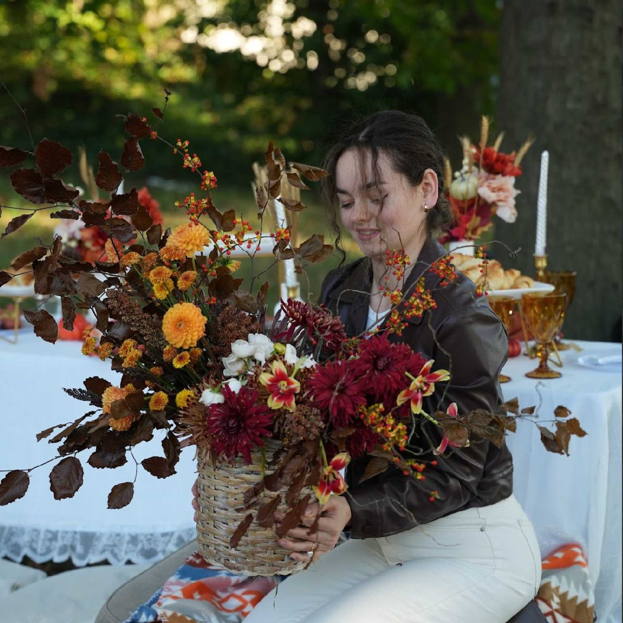 A beautiful fall-inspired basket arrangement featuring seasonal flowers in deep wine and