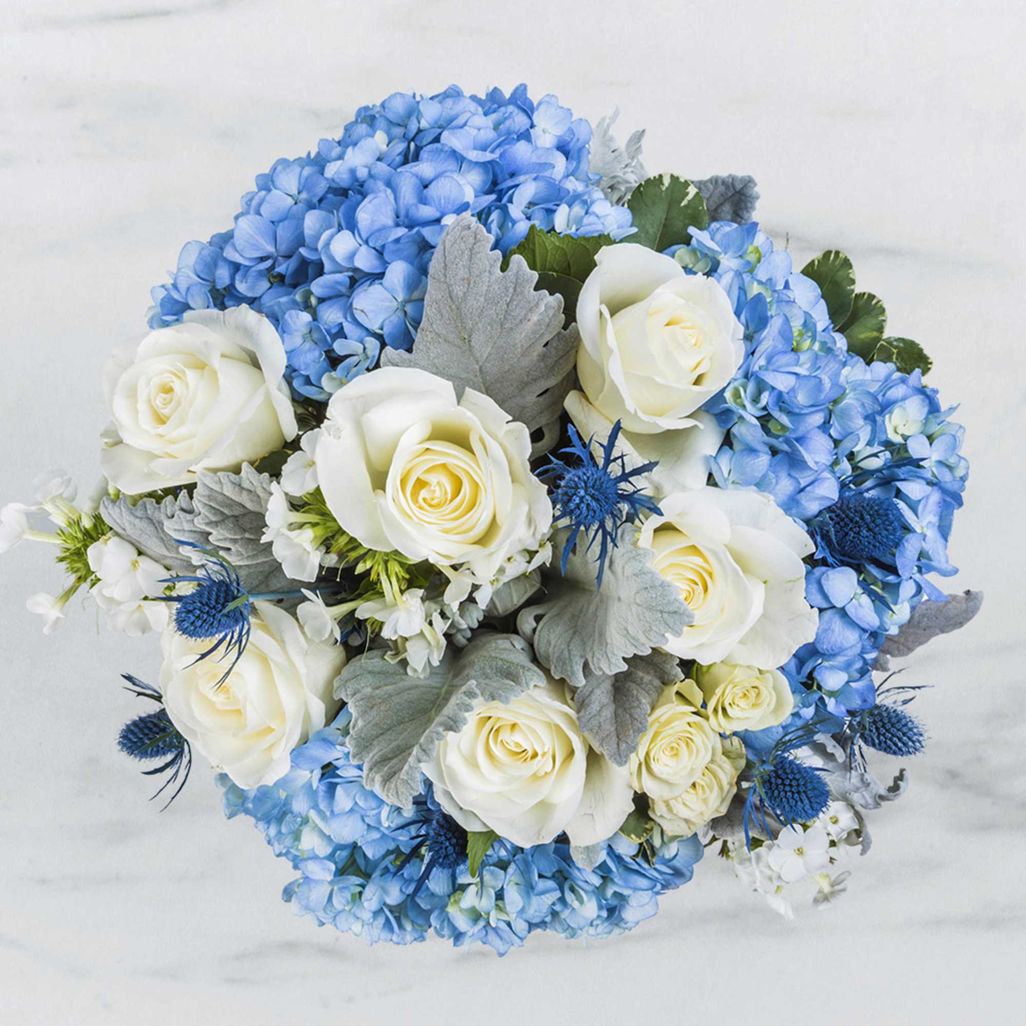A floral arrangement that uses the traditional colors of white and blue